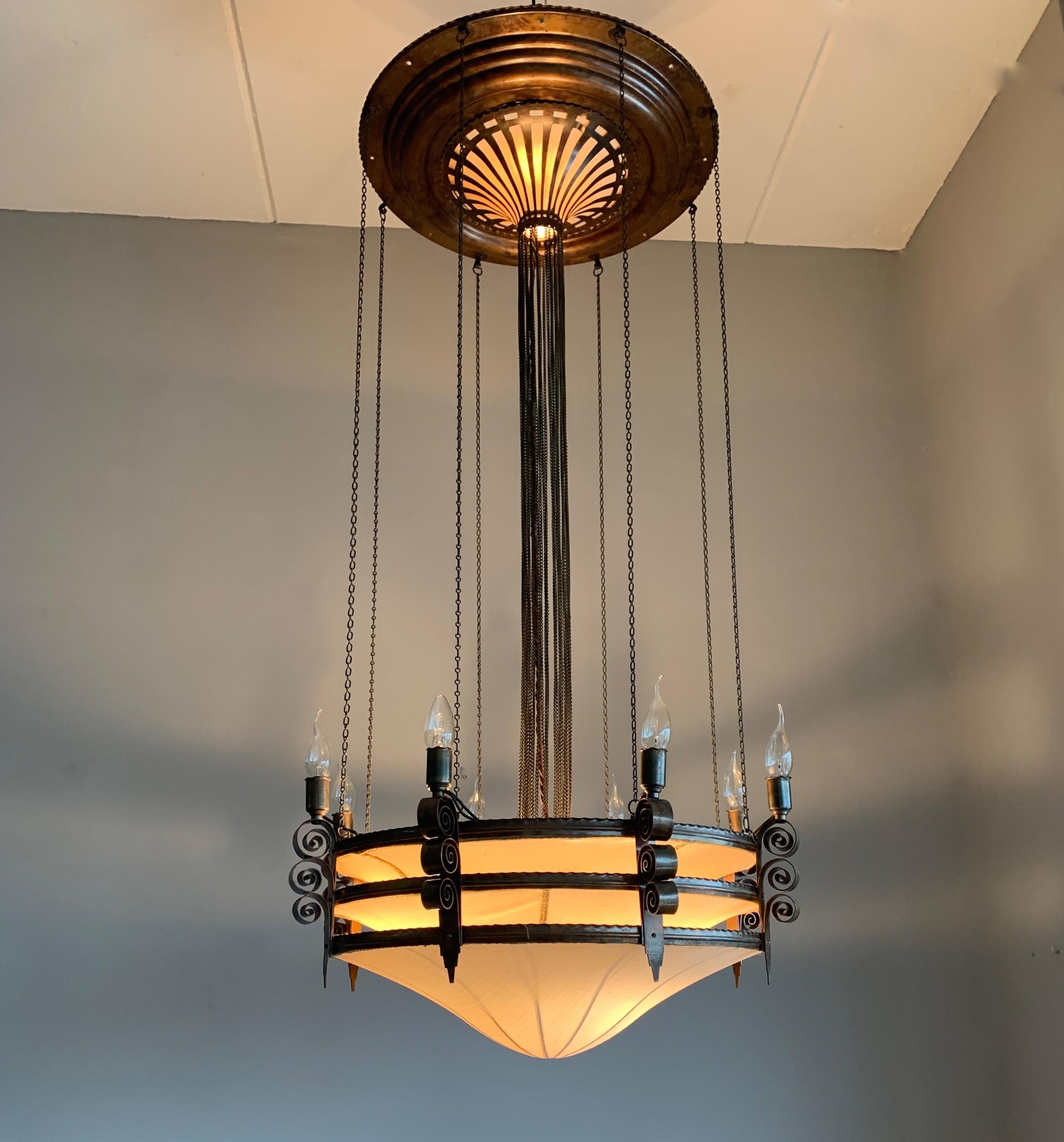 This large, striking and rare 12-light chandelier is part of an even rarer set of 4 fixtures.

If you live or work in an Arts & Crafts (inspired) building and you are looking for the perfect fixture to grace your living or work space then this very