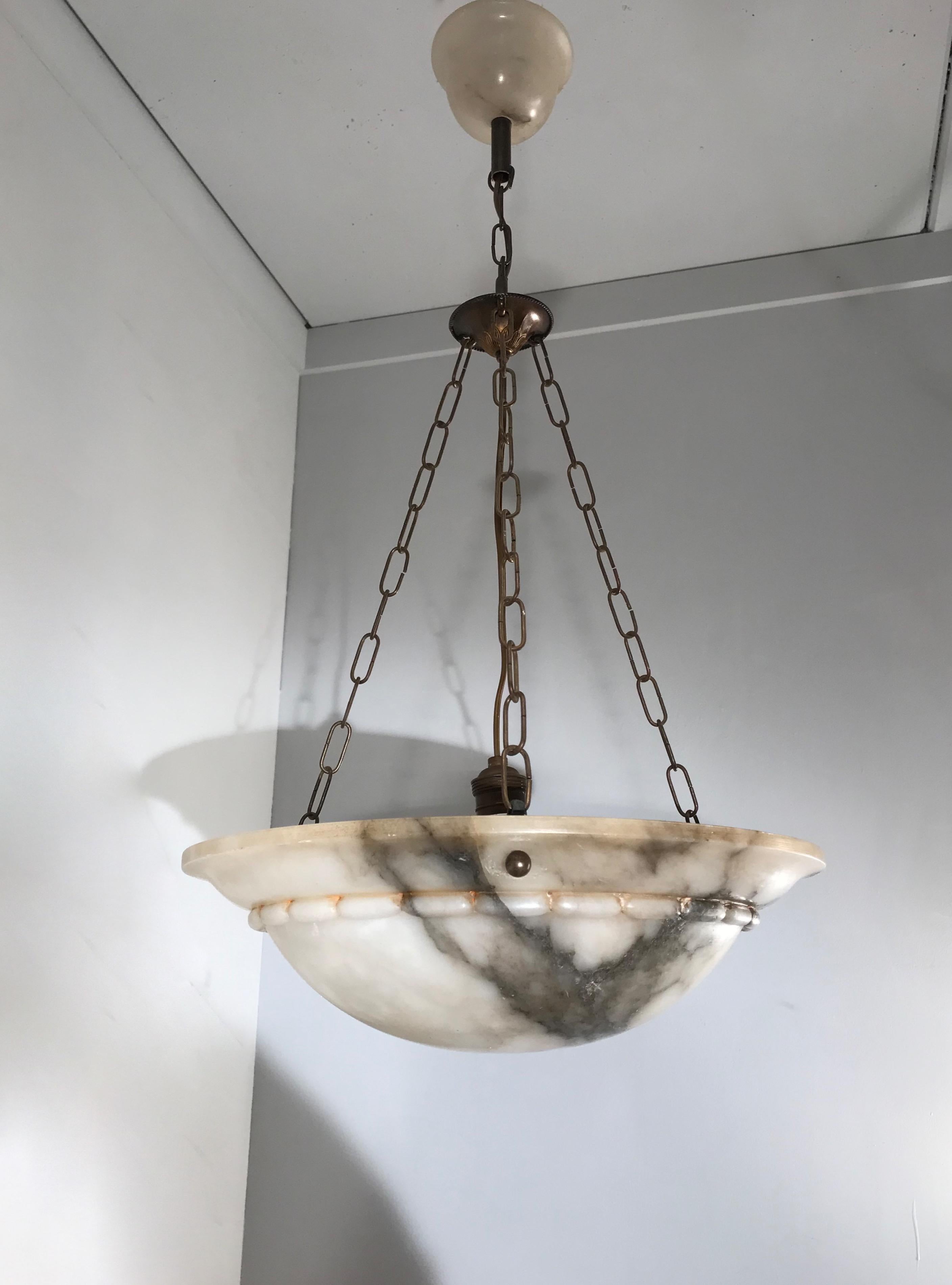 Top quality and highly stylish chandelier with the original alabaster canopy.

If you are looking for a fine quality, handcrafted and hand carved alabaster pendant from the Arts & Crafts era then this fine specimen could be ideal for you. The black