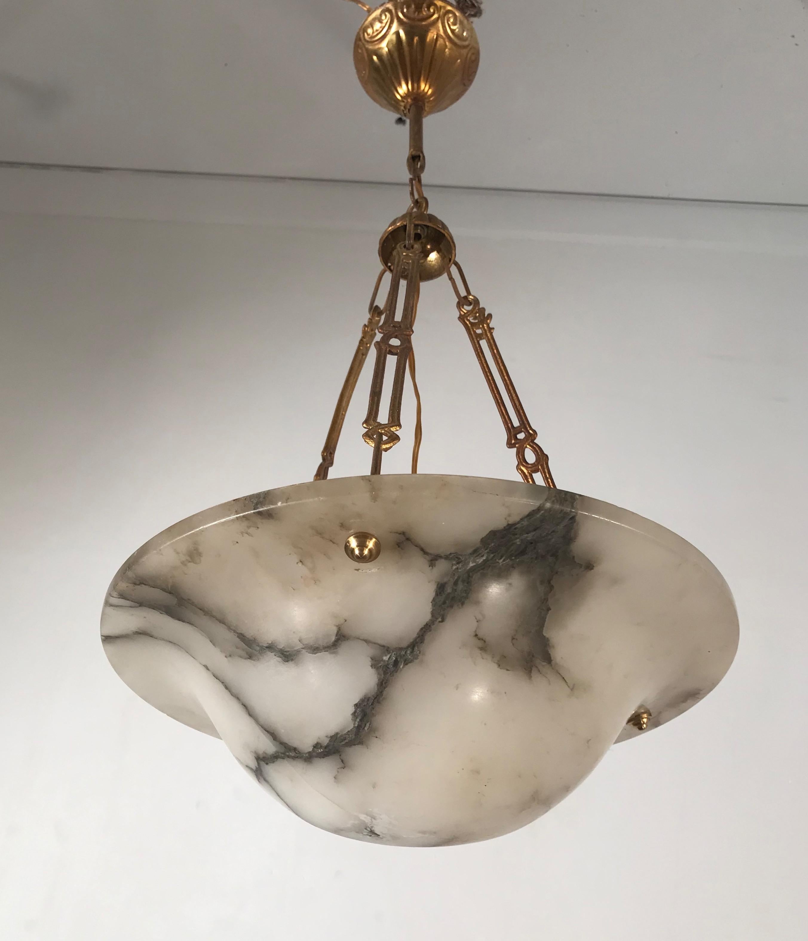 Small in size and highly stylish chandelier with rare brass chain.

If you are looking for a fine quality, handcrafted and hand carved alabaster pendant from the Arts & Crafts era then this Fine specimen could be ideal for you. The black veins in