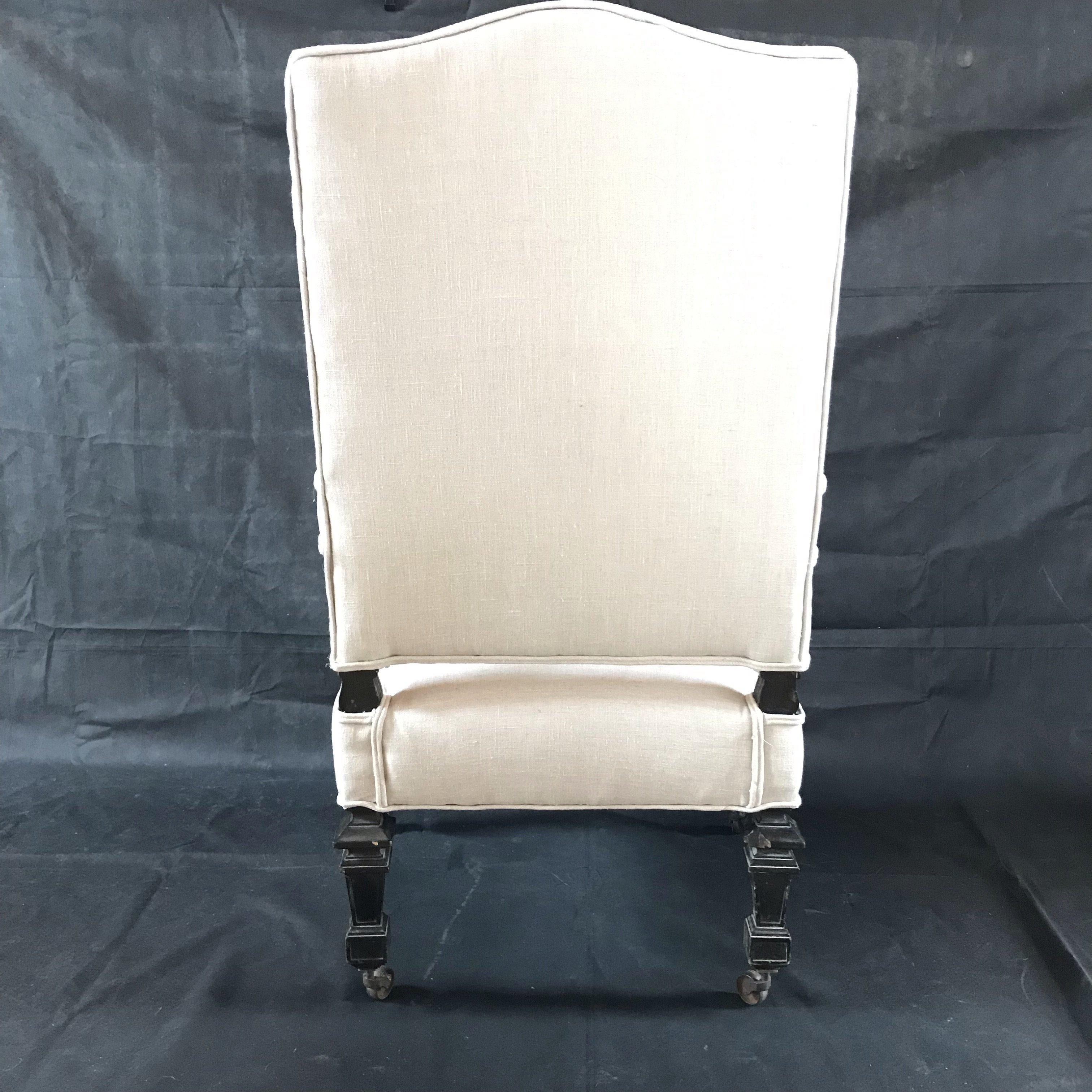 A sophisticated French Louis XIV antique armchair having beautiful hand carved arm rests of scrolling acanthus leaves. New crisp linen upholstery and original casters on feet. Pillow is additional $150.
#2047.

 