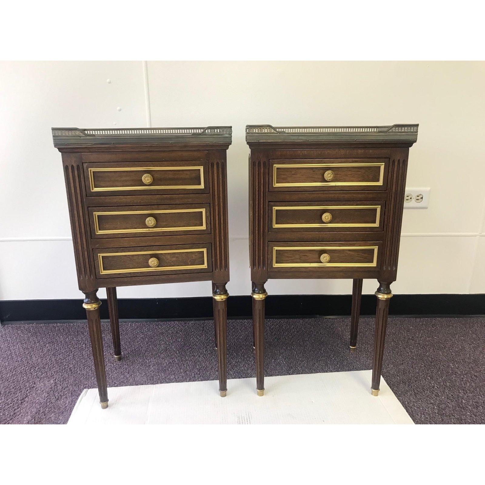 Pair of vintage French side tables from the Brittany region of France that are a rare find in this condition and quality. Each is adorned with an original brass gallery around the solid Carrara marble top, brass also accents the front of all three