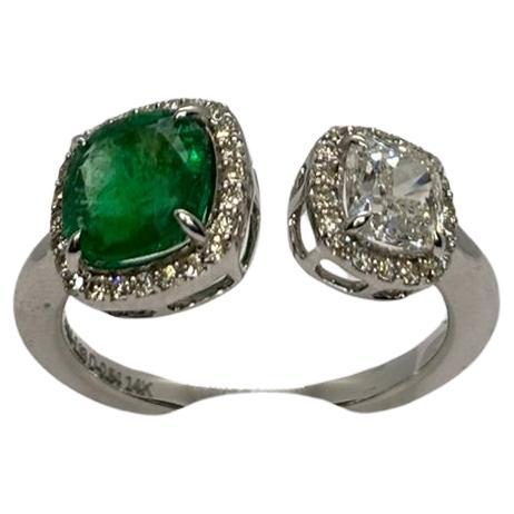 This stunning ring features a vibrant emerald and Cushion Cut Diamond surrounded by a halo of sparkling diamonds that enhance its rich green hue. Set in high-quality metal, the emerald exudes a timeless elegance, while the diamonds add a brilliant
