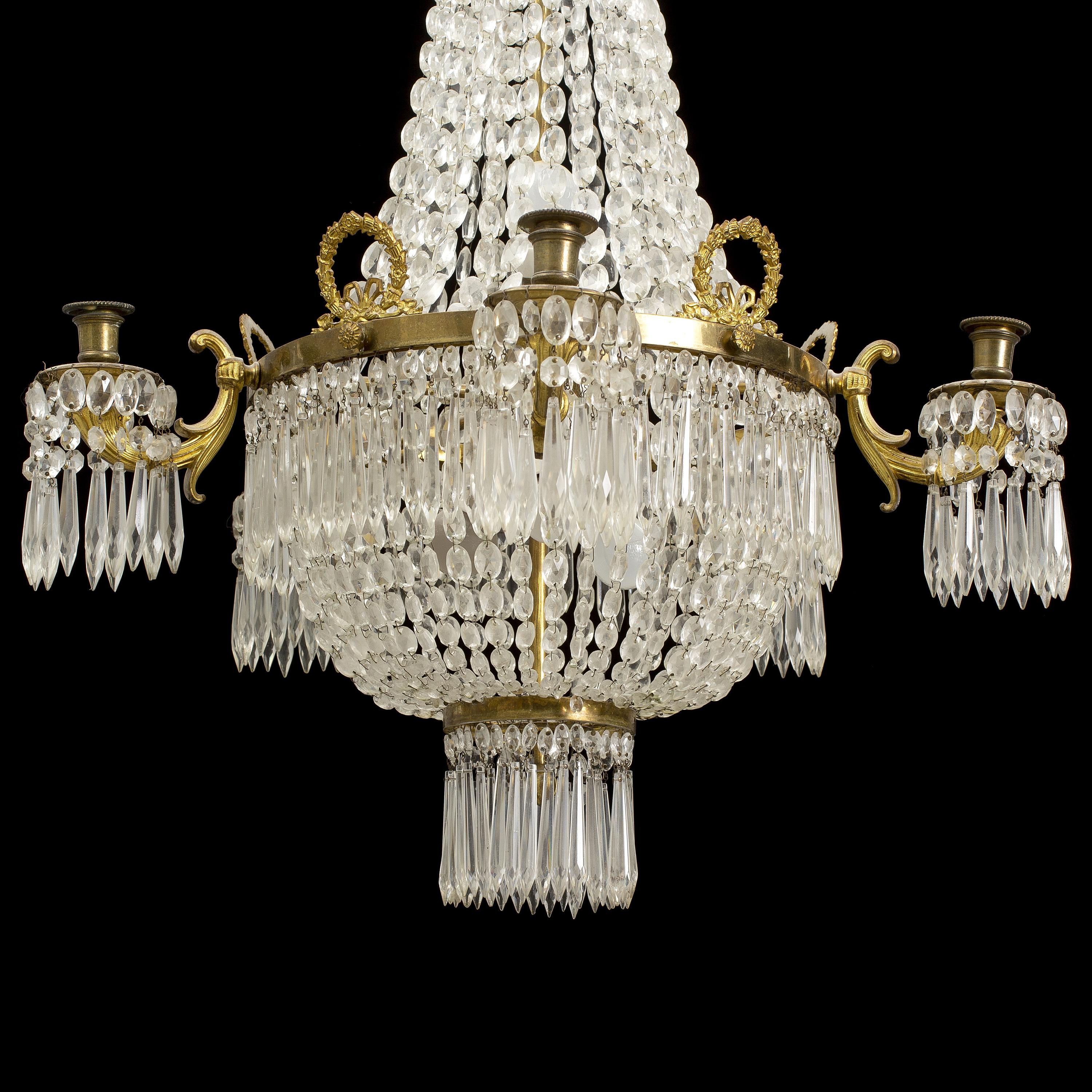 A Scandinavian brass and cut-glass crystal chandelier from the end of the 19th century. It is wired and in excellent condition. Chain not included but if requested we will add chain and canopy.
Measures: Diameter 69, height 105 cm.
