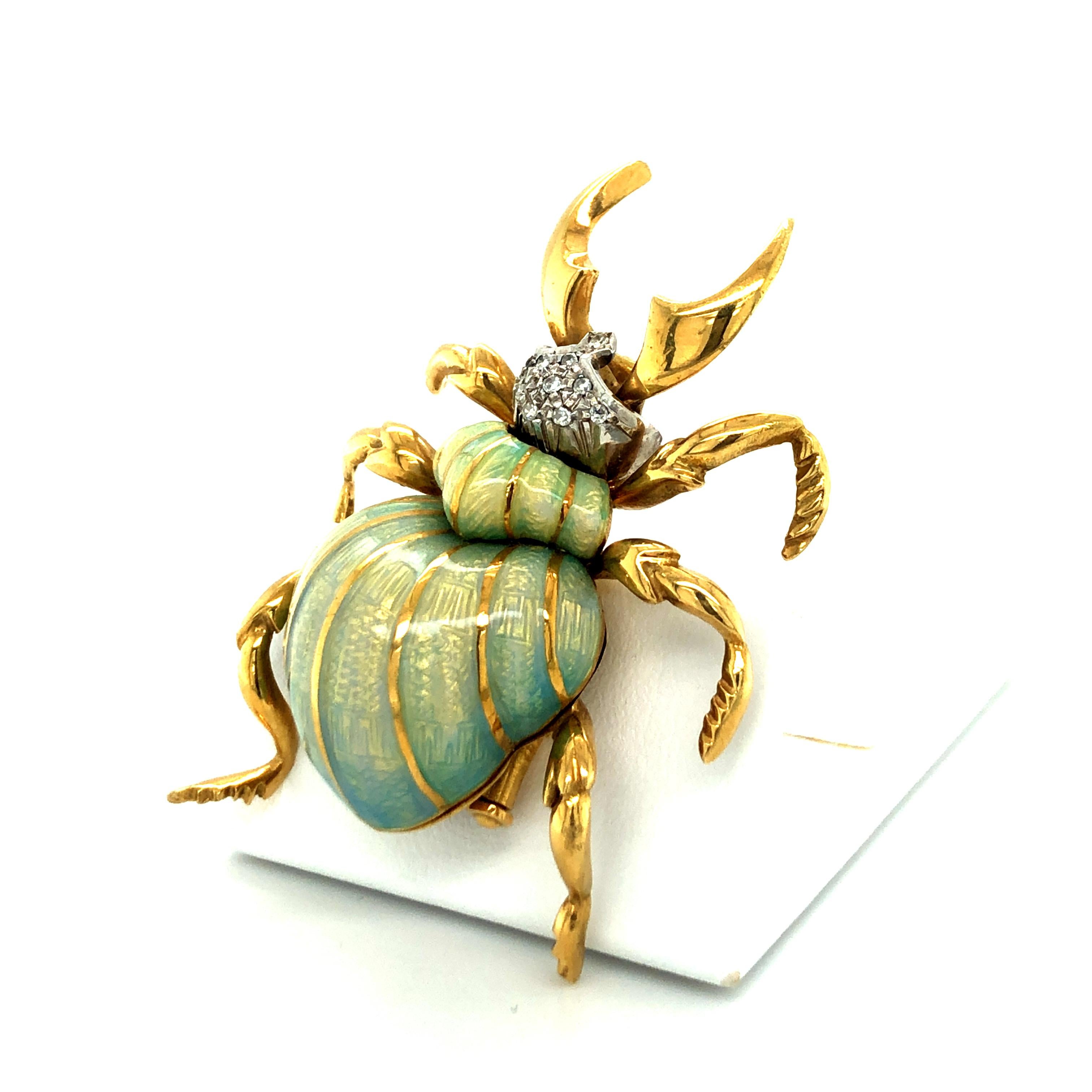 This beautiful example of a beetle brooch ressembles a stag beetle with its impressive antlers. This unique brooch is carefully handcrafted in 18 karat yellow gold and white gold and is superbly enamelled in a delicate shade of green. This technique