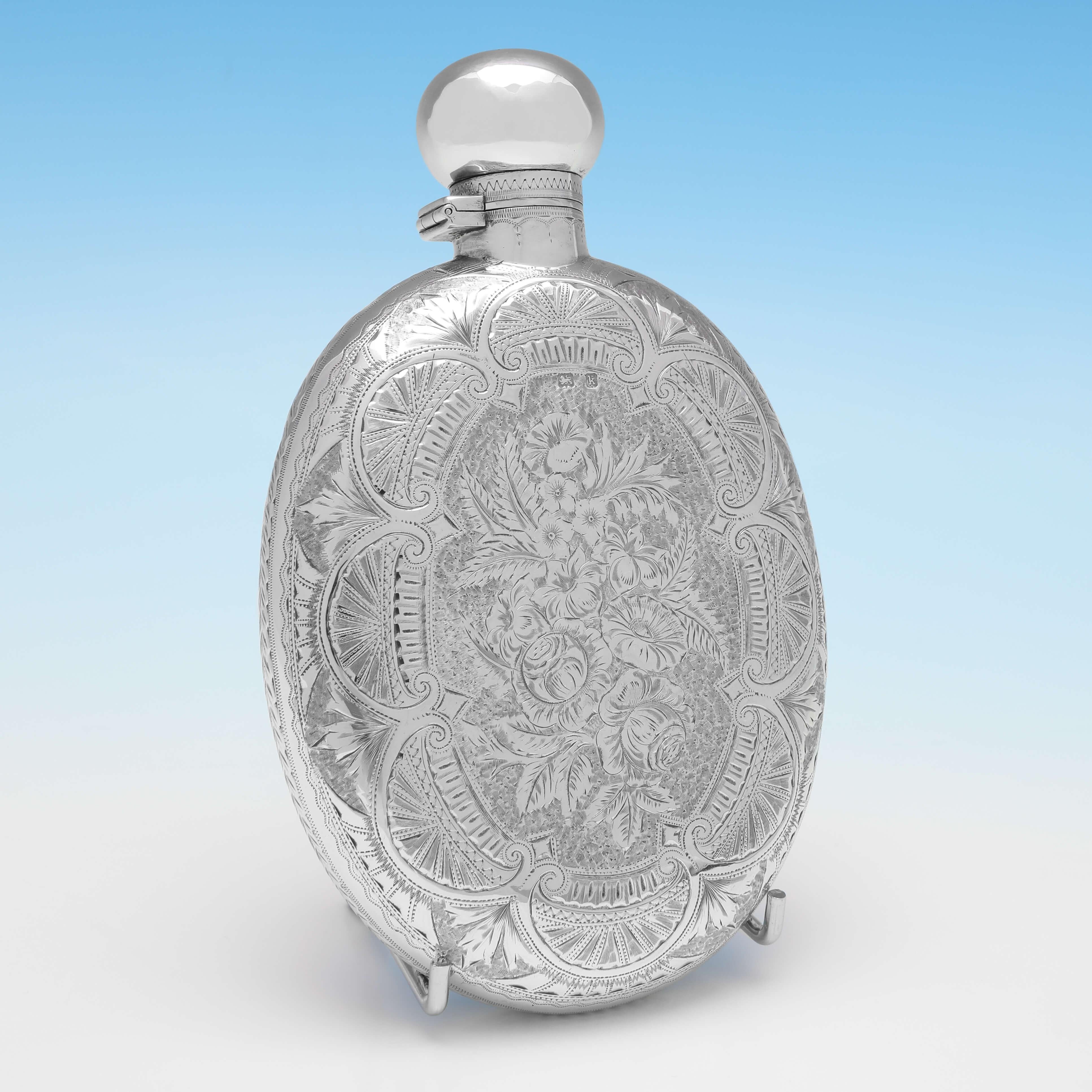 Hallmarked in Birmingham in 1909 by Joseph Gloster Ltd., this stunning, Victorian, Antique Sterling Silver Hip Flask, is oval in shape, and features a bayonet cap and striking bright cut engraved decoration to the body. The hip flask measures