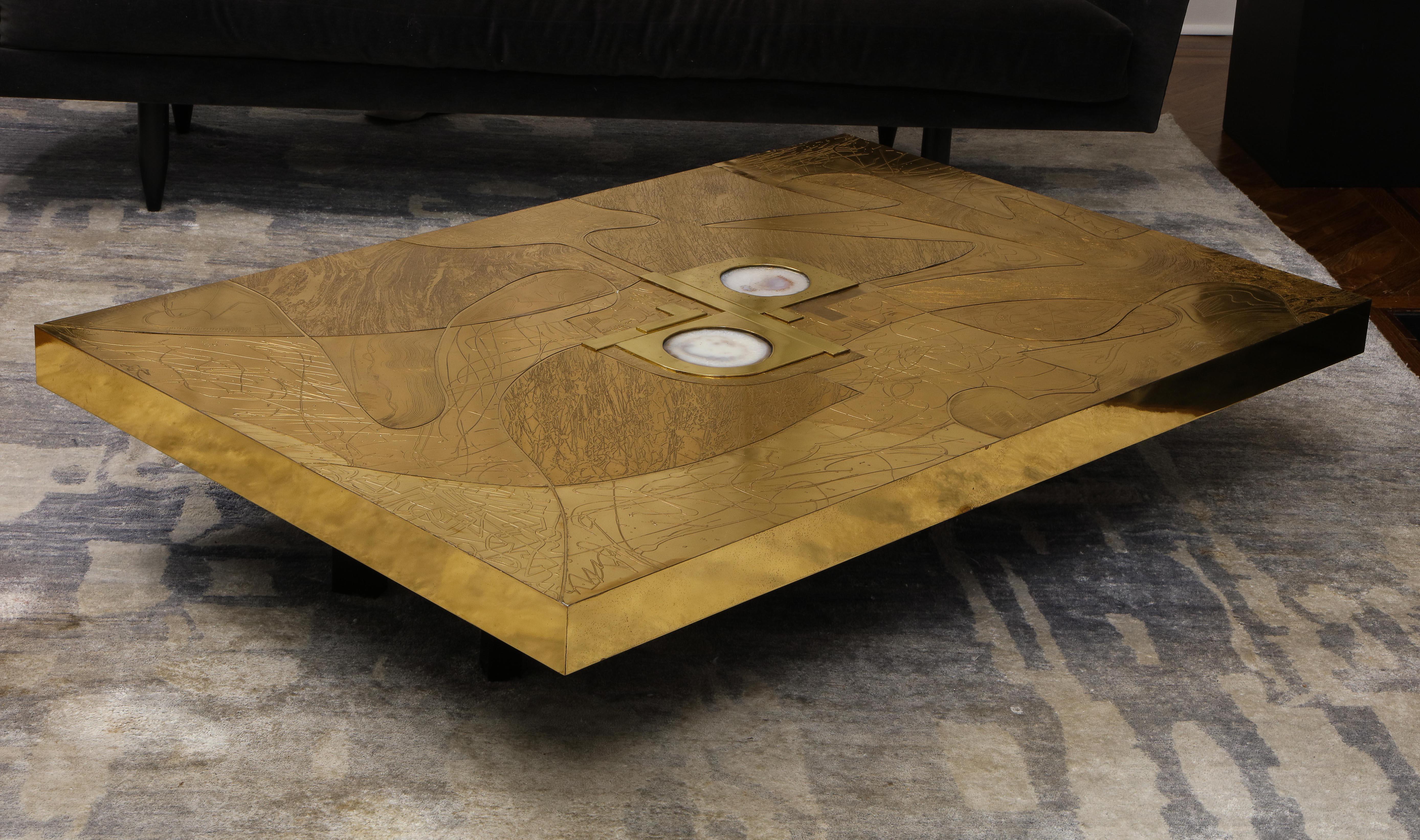 Stunning etched brass and double agate cocktail table. This is a one of a kind, off the floor model that is available for immediate purchase for a discounted price. The table is in good condition with minor scratches and blemishes that are