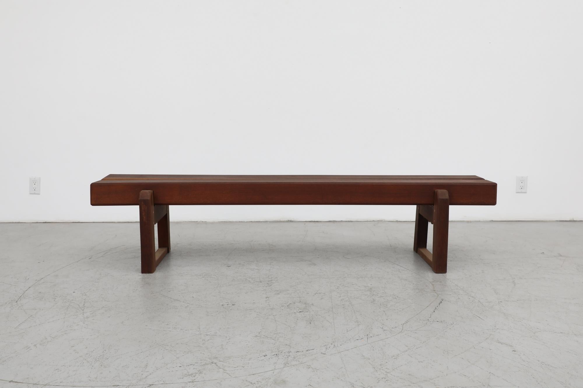 Brutalist, Mid-Century, extra long and extremely heavy solid wood bench. From outside of a library in Belgium. The bench is lightly sanded and hand waxed with visible patina and wear that is consistent with its age and use. This bench may vary
