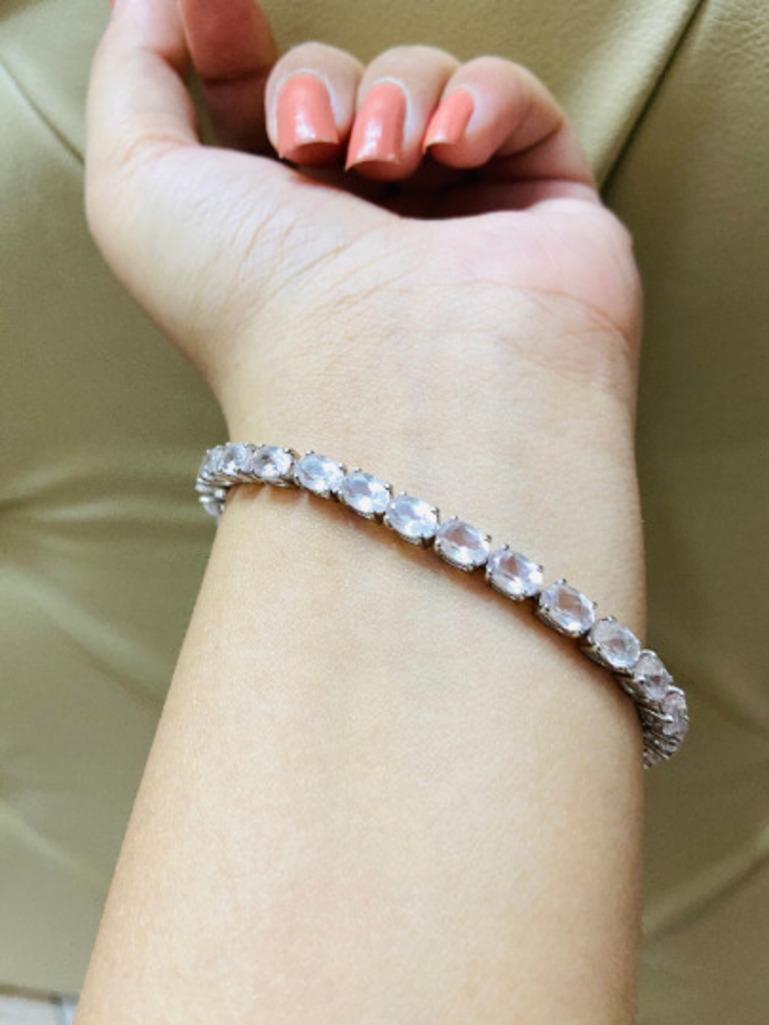Stunning Faceted Rose Quartz Tennis Bracelet in sterling silver showcases endlessly sparkling natural rose quartz, It measures 7 inches long in length. 
Rose Quartz stimulate concentration and reduces stress. 
Designed with perfect oval cut rose