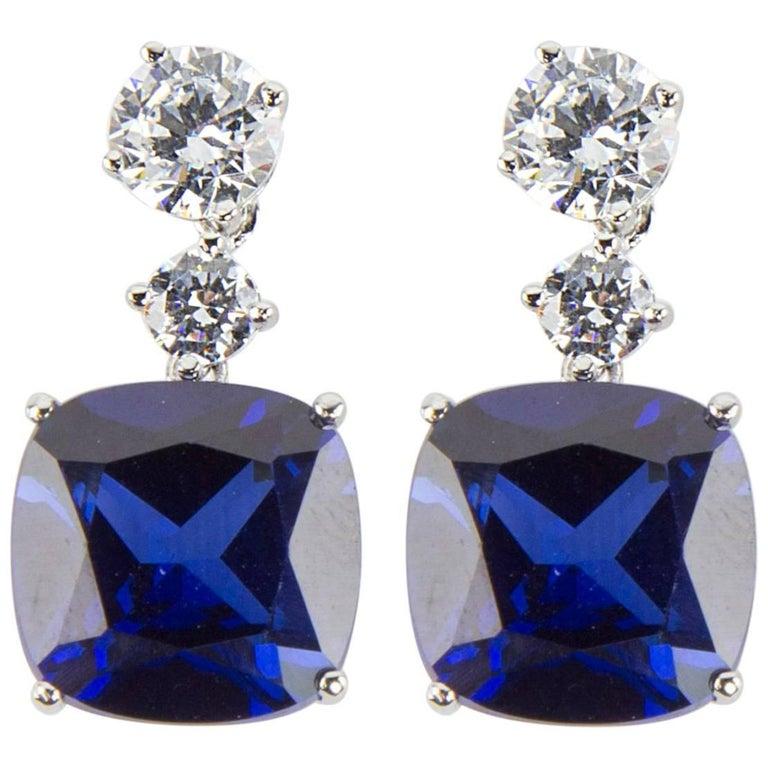 Simply Beautiful…each dangle earring is set with a 6mm and a 4mm round Faux Diamond, suspends a large 22mm square cushion shape faux Blue Sapphire, making a striking statement! All hand set in Sterling Silver. Approx. total length 1