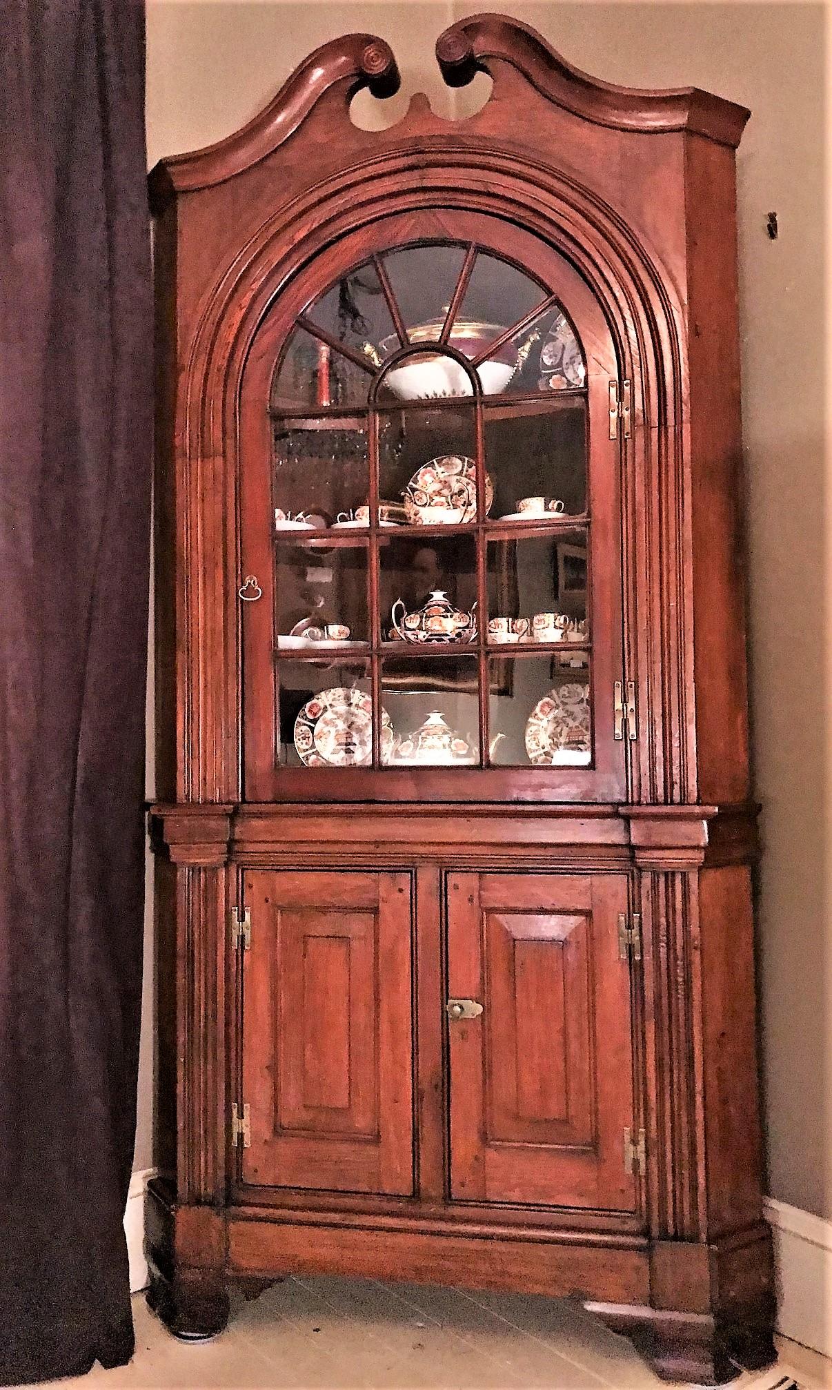 This late Georgian pine corner cupboard, more than 200 years old, bears all the hallmarks of a piece of architectural detail from a circa 1815 house of a wealthy Virginian of the era. It was long ago converted into a piece of free-standing