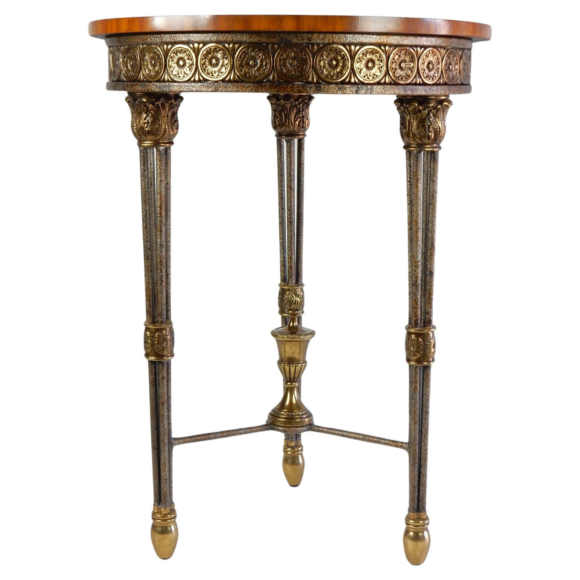 Stunning geometric floral flame Mahogany inlayed top Gueridon table
by Maitland Smith. Stands 32-1/2in tall X 24in wide.
Surround brass floral reliefs, iron legs and large egg shape brass feet.
Huge trophy finial centerpiece.
Labeled 