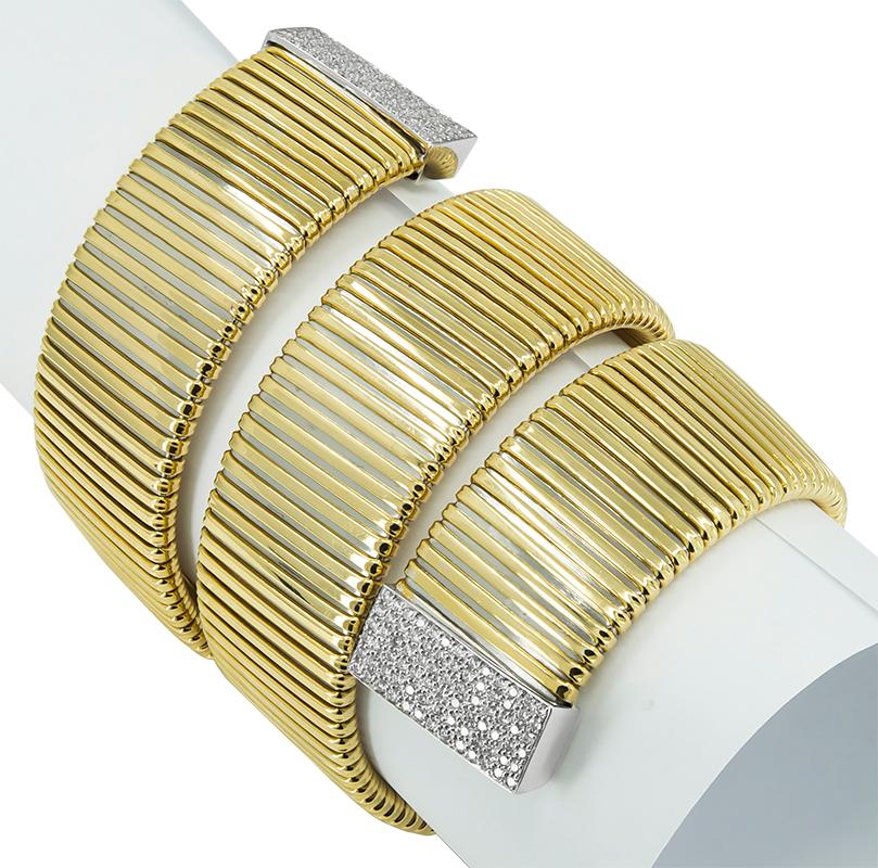 Gorgeous and striking flexible bracelet that wraps around the wrist. Deeply engraved line pattern in 18K yellow, with both platinum ends encrusted with diamonds (approx. 4.50 cts), set in platinum. Fits a medium to large wrist. A distinctive and