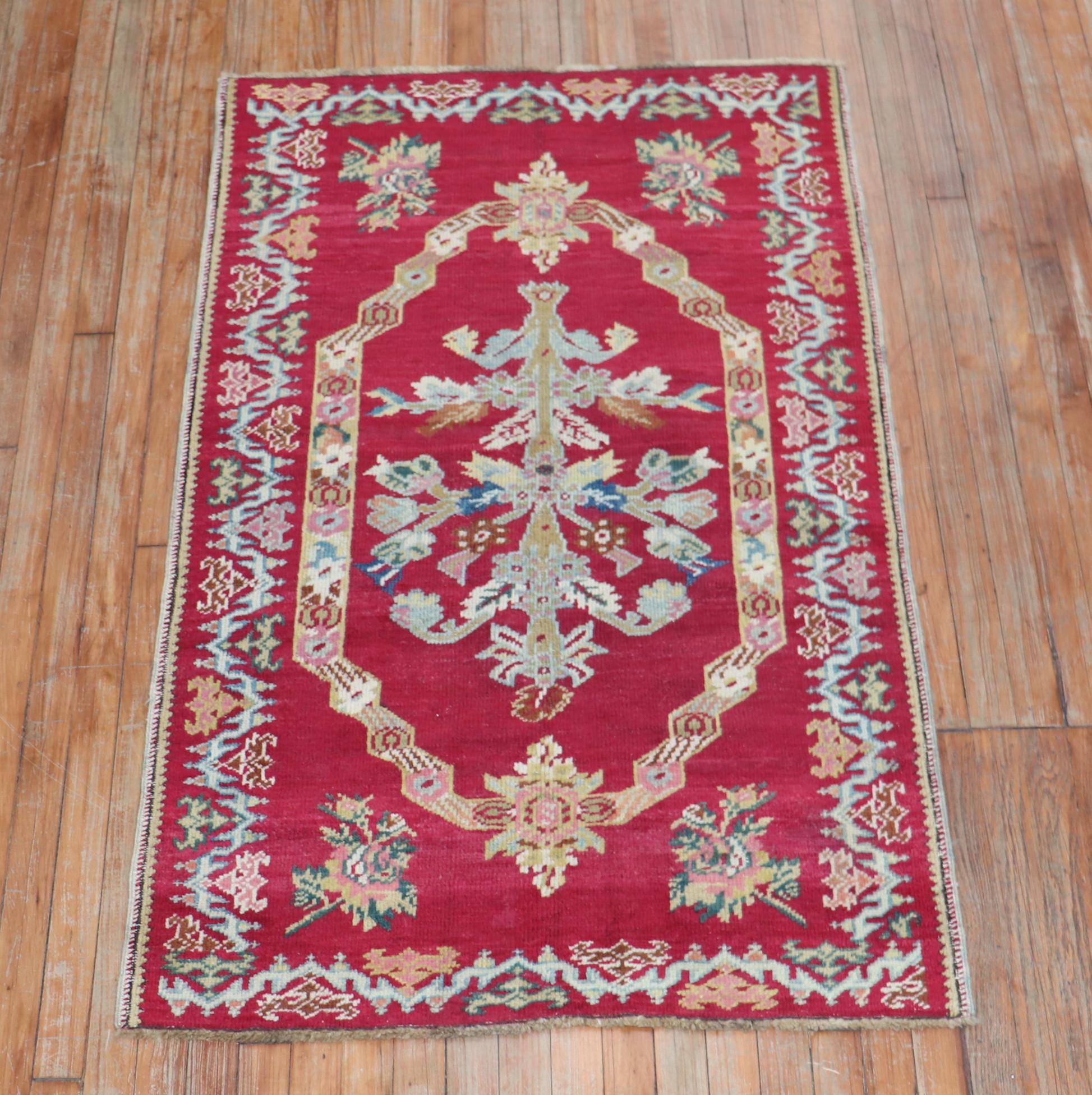 A charming handmade small antique Turkish rug. Predominantly raspberry including other exotic colors.

Measures: 3'3'' x 5'3''.
