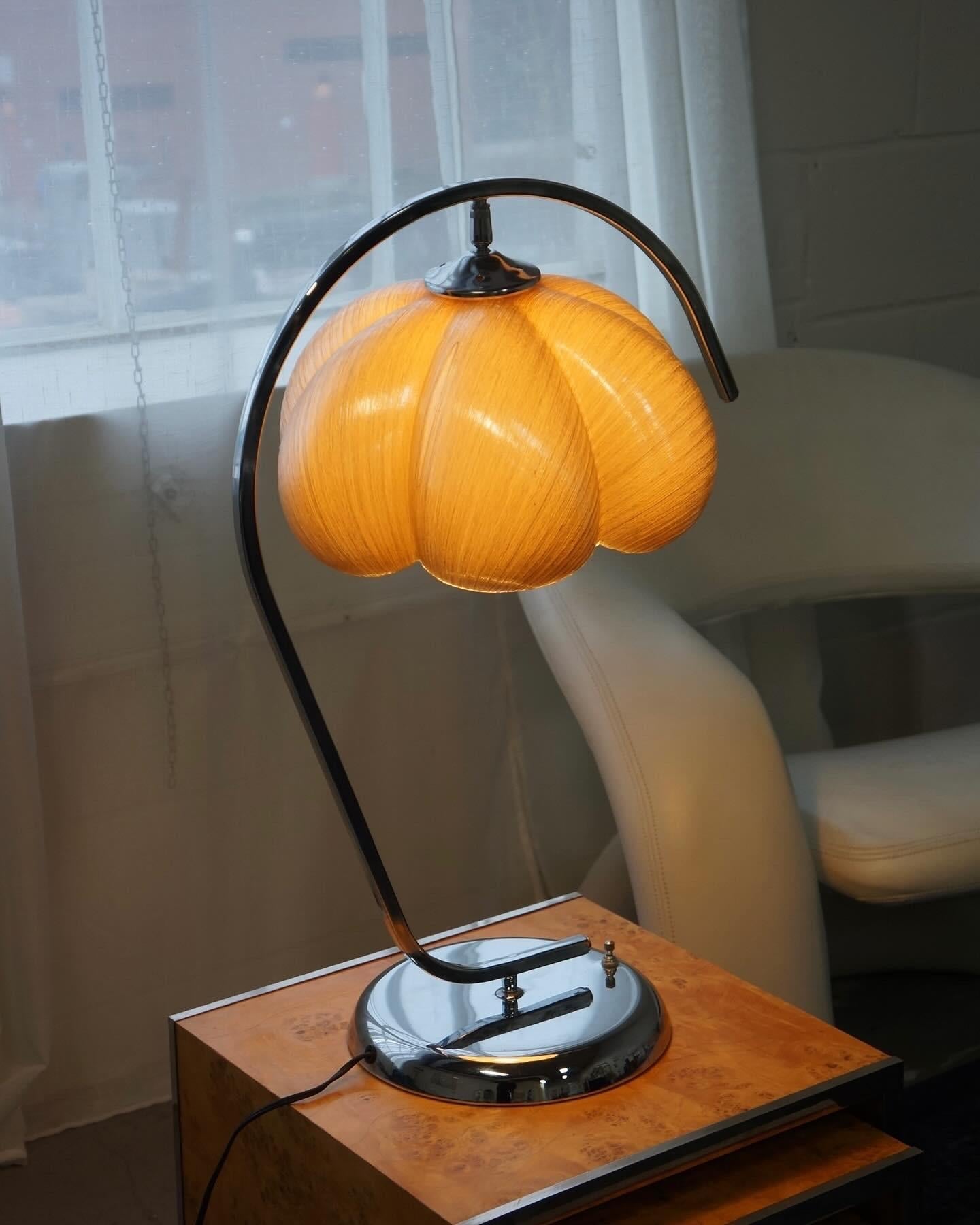 Stunning and unique fibreglass and chrome table lamp from the 1970s. This spectacular table lamp has a curvature to its body with an arch top which seemingly wraps around the shade. The shade is a fiberglass in a soft and muted grey, light yellow
