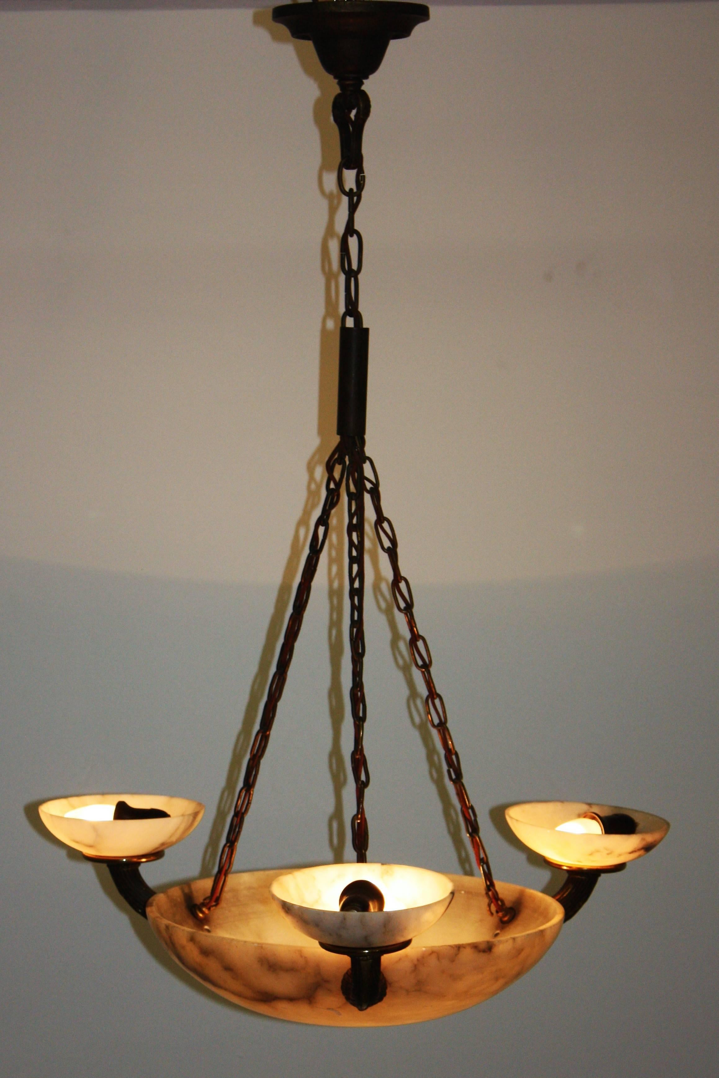Stunning four-light alabaster and solid bronze pendant, circa 1900s.
Large round shade with three bronze arms and brass frame (fine patination).
Socket: Four x E27 (Edison) for standard bulbs.
With original wiring.