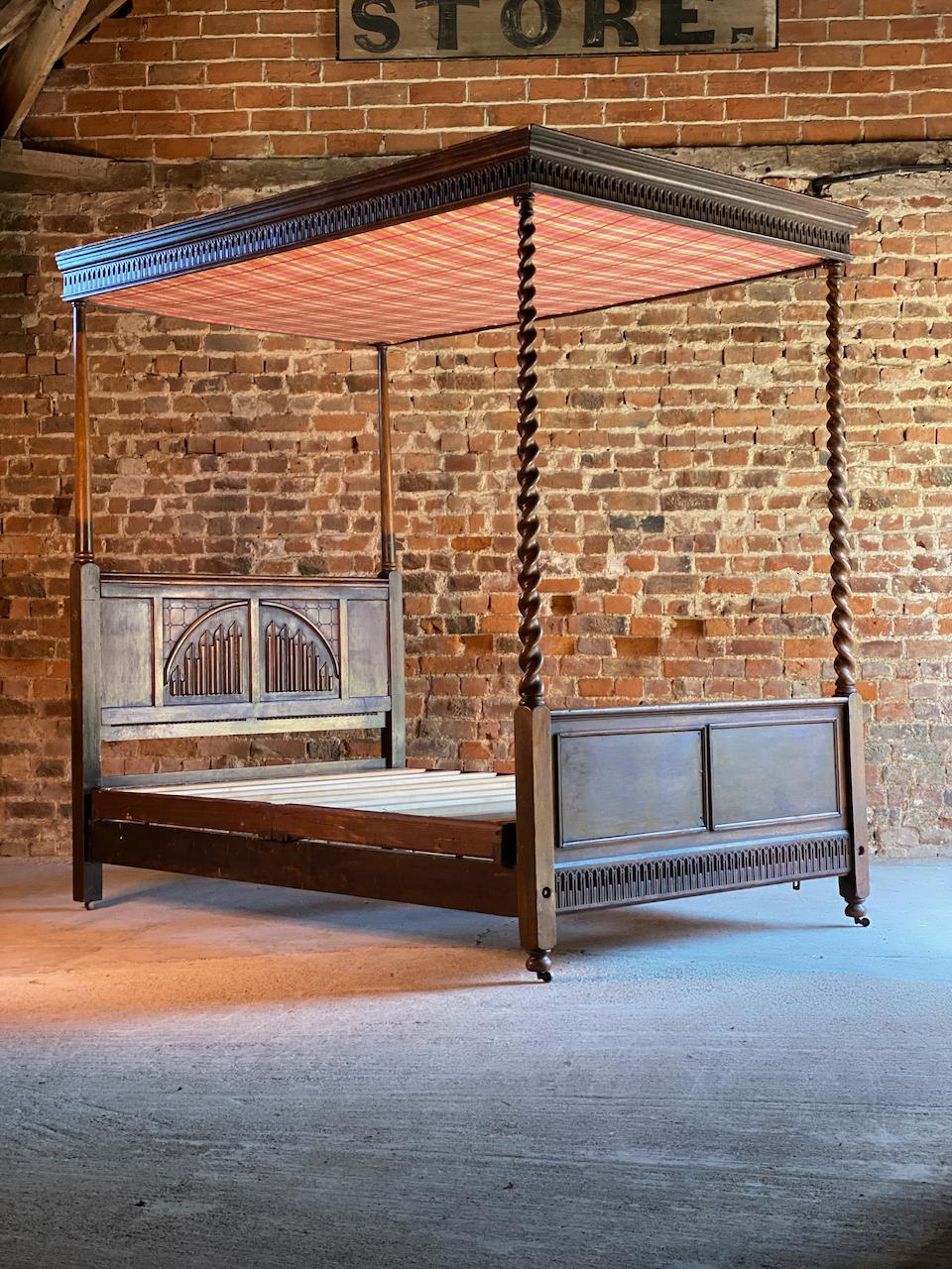 A magnificent and decadent oak four poster bed with barley twist turned uprights and a linen headboard France 1890, magnificently carved and beautifully-articulated. The Barley twist turned uprights are elegant and stylish. Bed frame having strong