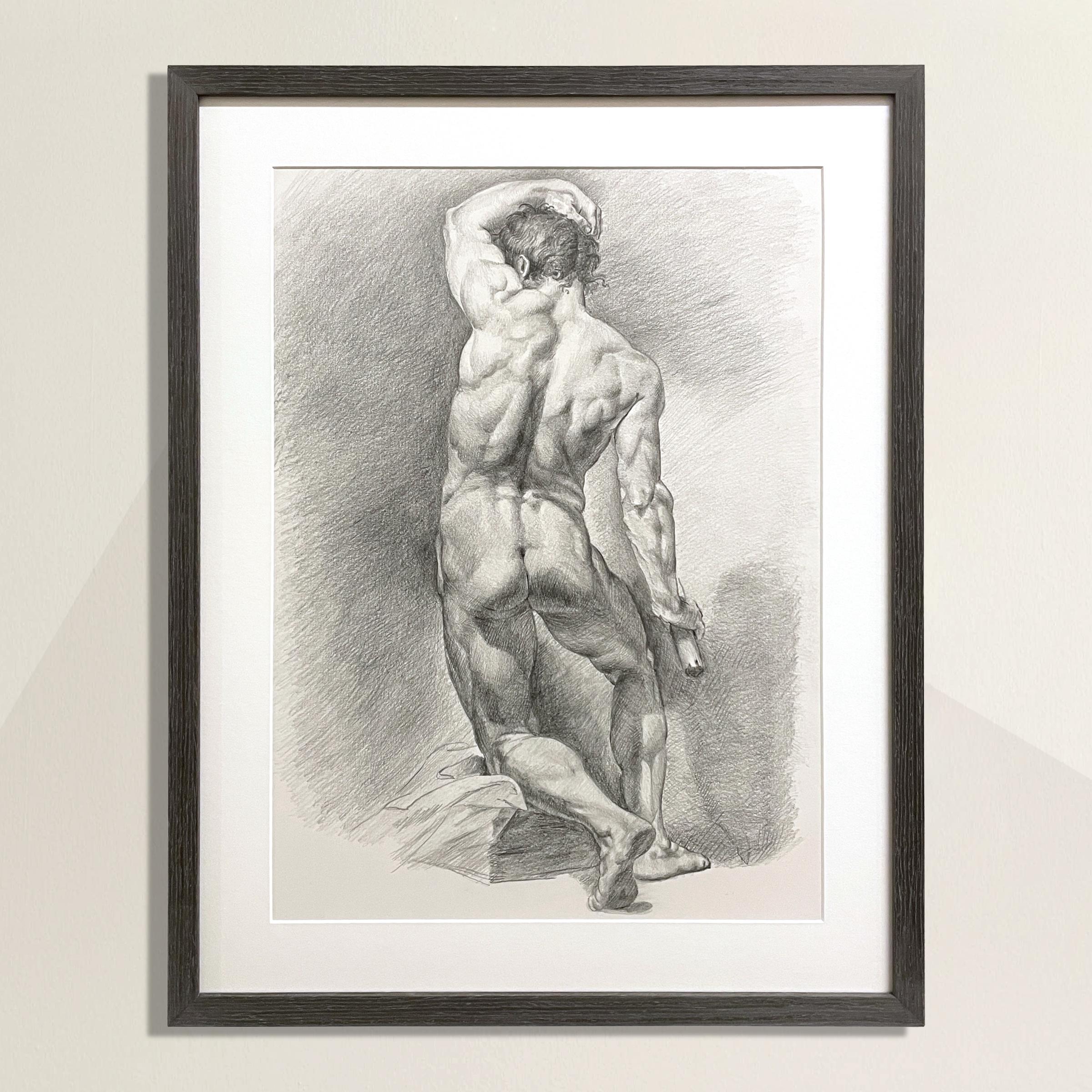 A stunning late 20th-century academic graphite-on-paper male figure drawing showcasing a skillful attention to musculature, highlights and shadows, and with a classical Renaissance-inspired sensibility. Framed in a new driftwood gray gallery frame