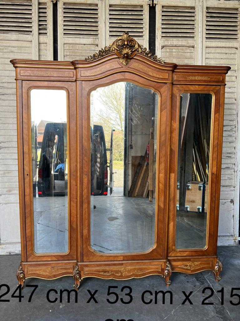 A truly superb quality French 3 door Armoire. Made from walnut and having its original bevelled mirrors. The central is hanging and the 2 sides are shelved but these could be easily converted to hanging with the addition of rails. 
It has some