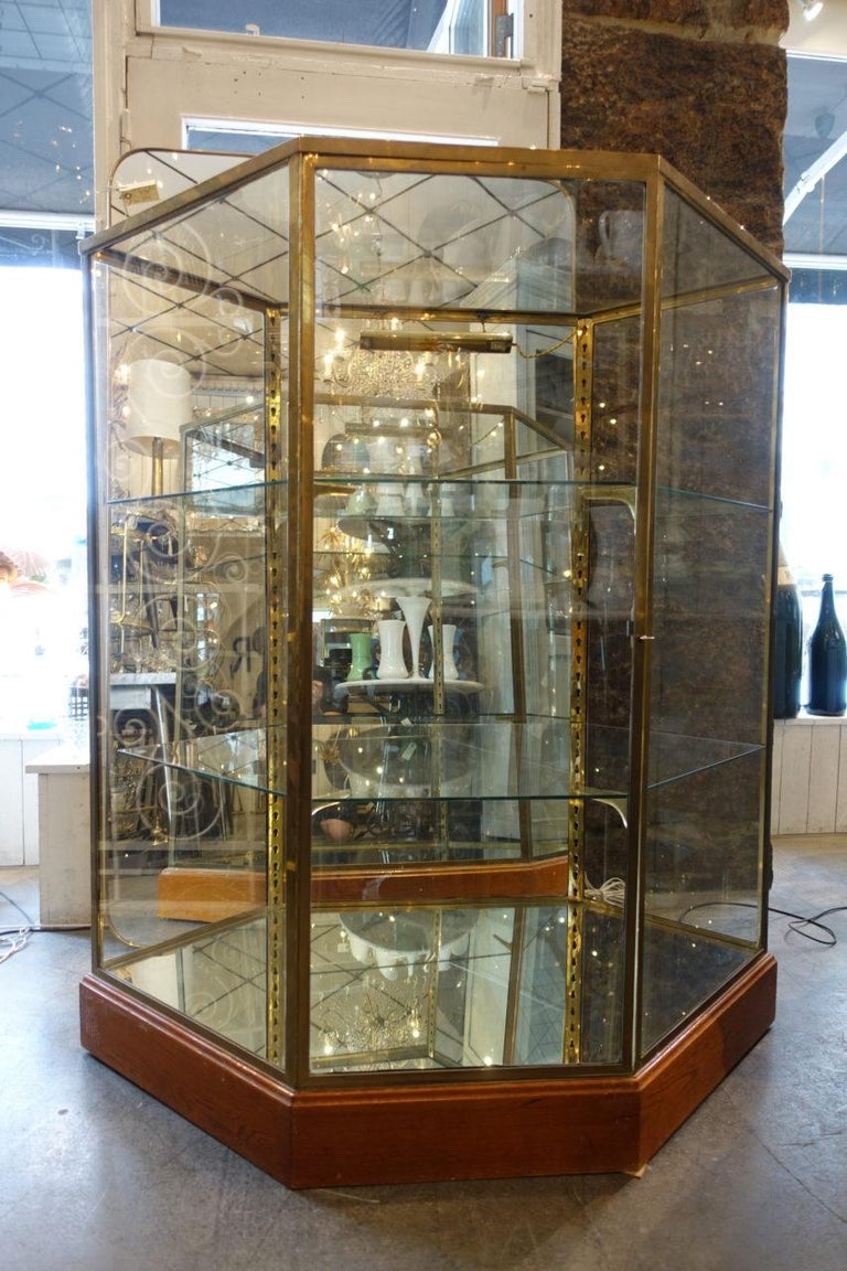 Tall handsome French 6-edged shop showcase / display cabinet, from the beginning of the last century. Beautiful detailing. Originally part of a boutique inventory, from an exclusive department store in Lyon, where it was used to display fine leather
