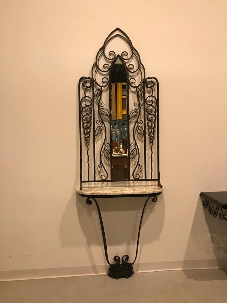 Beautiful French Art Deco console table. Having marble-top with a wrought iron mirror above. Stunning scroll work with gorgeous deco details. 

Console:
36 in.H x 35.5 in.W x 10.5 in.D

Mirror:
64 in.H x 32 in.W x 4.5 in.D.
 
 