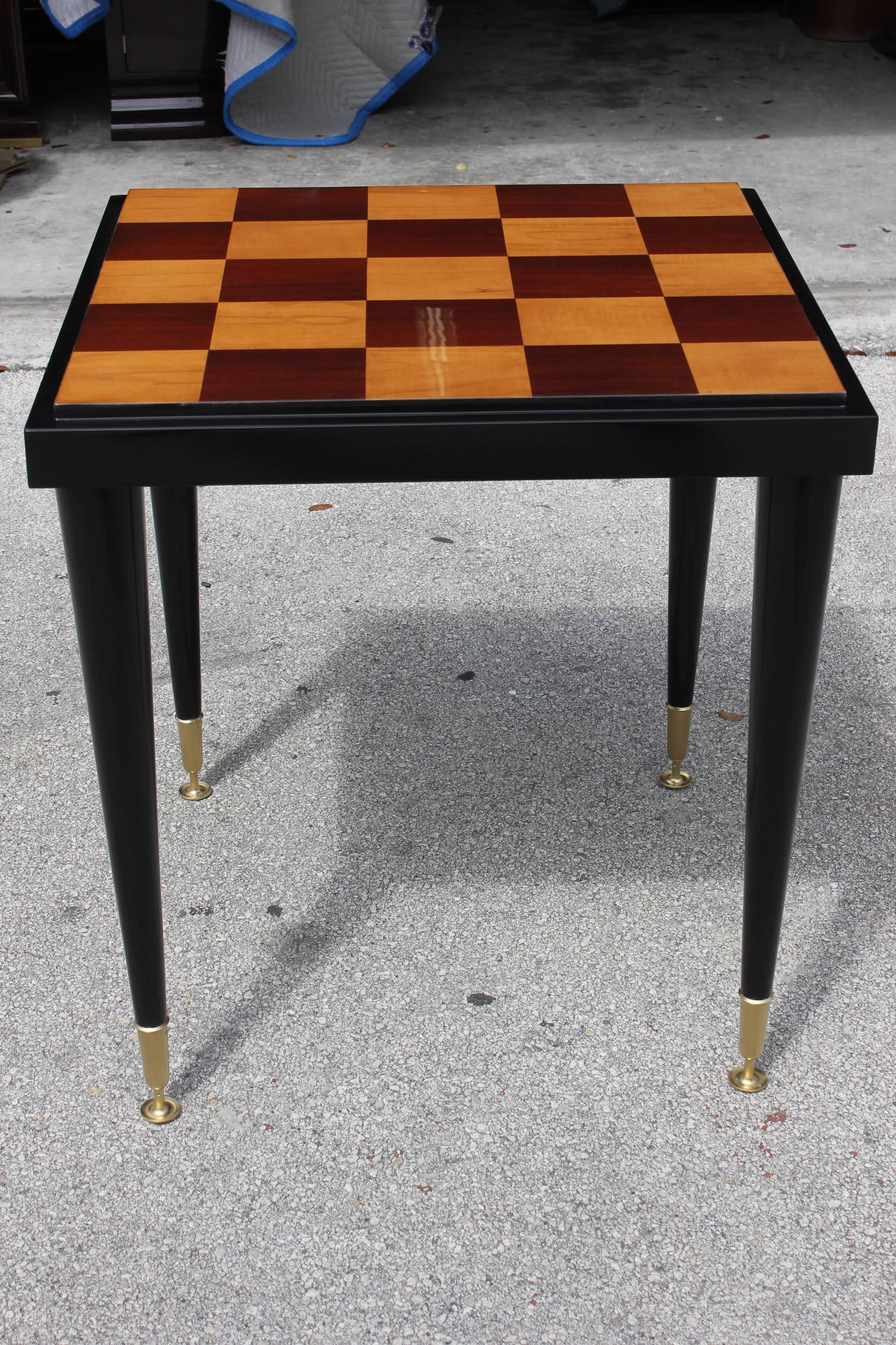 A French Art Deco marquetry ebony and sycamore center table or game table, steeped top.