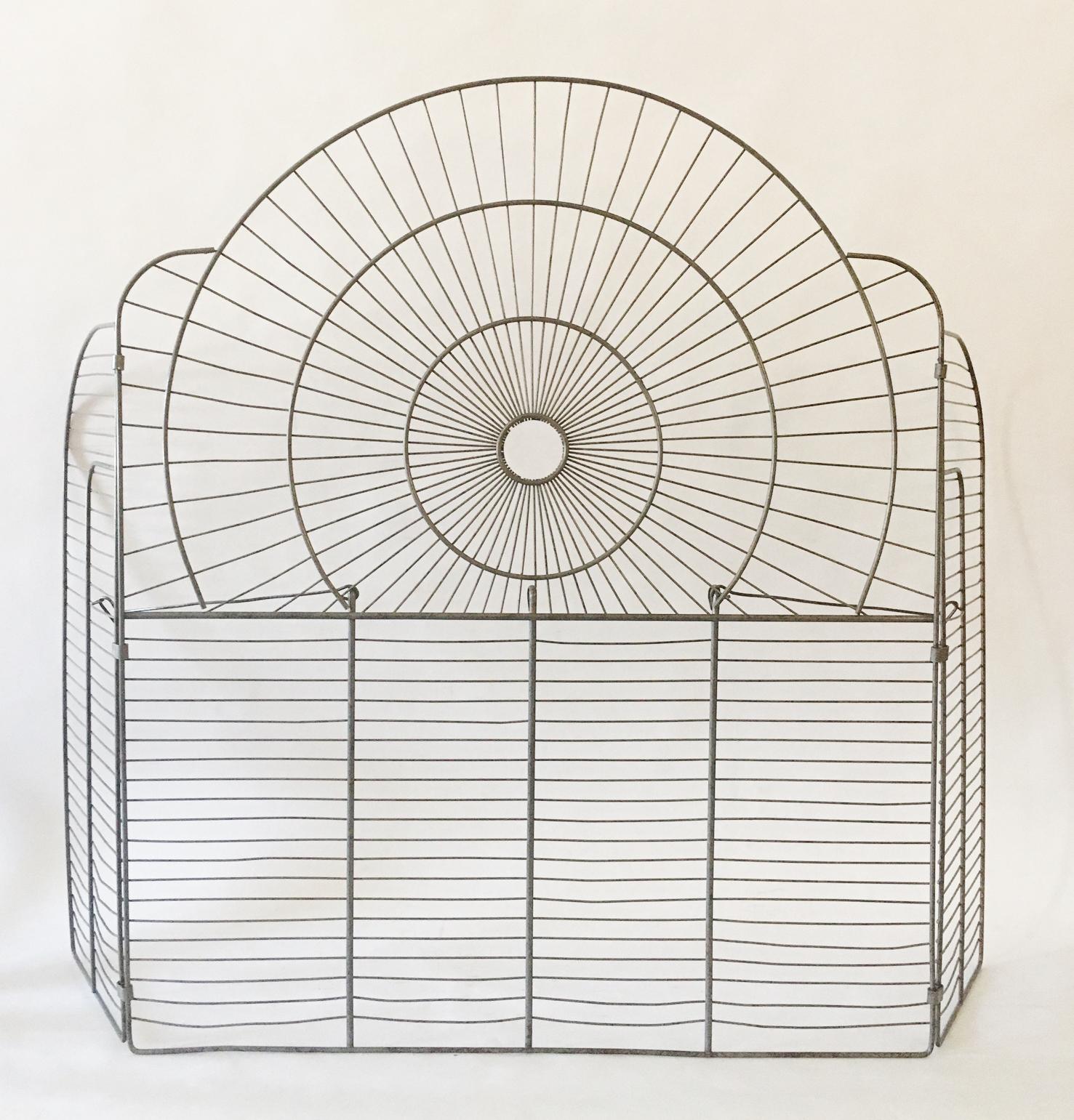 This exquisitely designed French Art Deco fire screen is hand constructed from two different gauges of wire and is one of the finest examples of these unique fireplace accessories that we have ever seen. It has the iconic Odeon shape with two