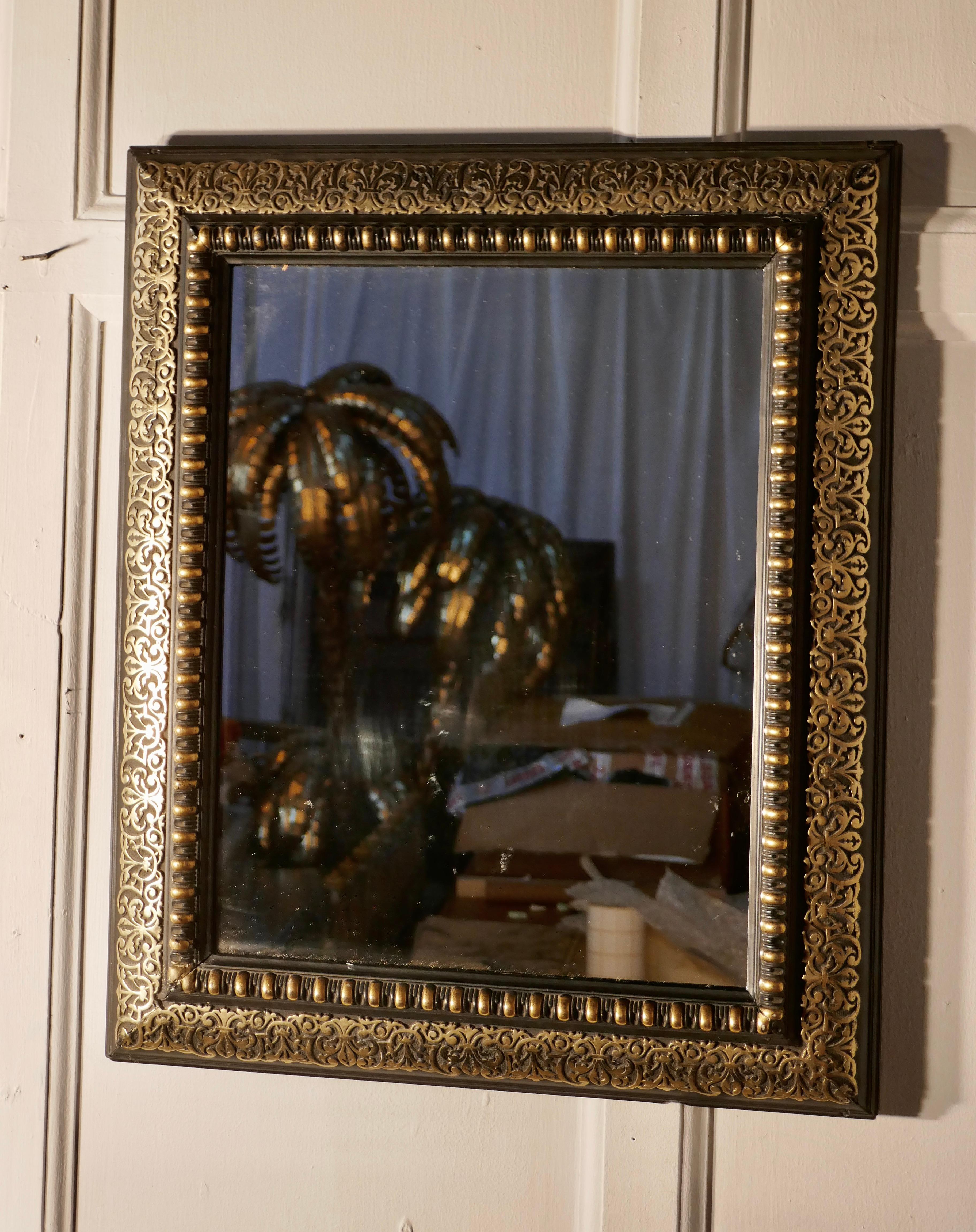 Stunning French Empire gilt brass and black lacquer wall mirror

This is a wonderful piece, the rectangular frame is decorated with a 4” wide pierced brass border, the inner part of the frame is in black and gilded gesso
This is a very lovely
