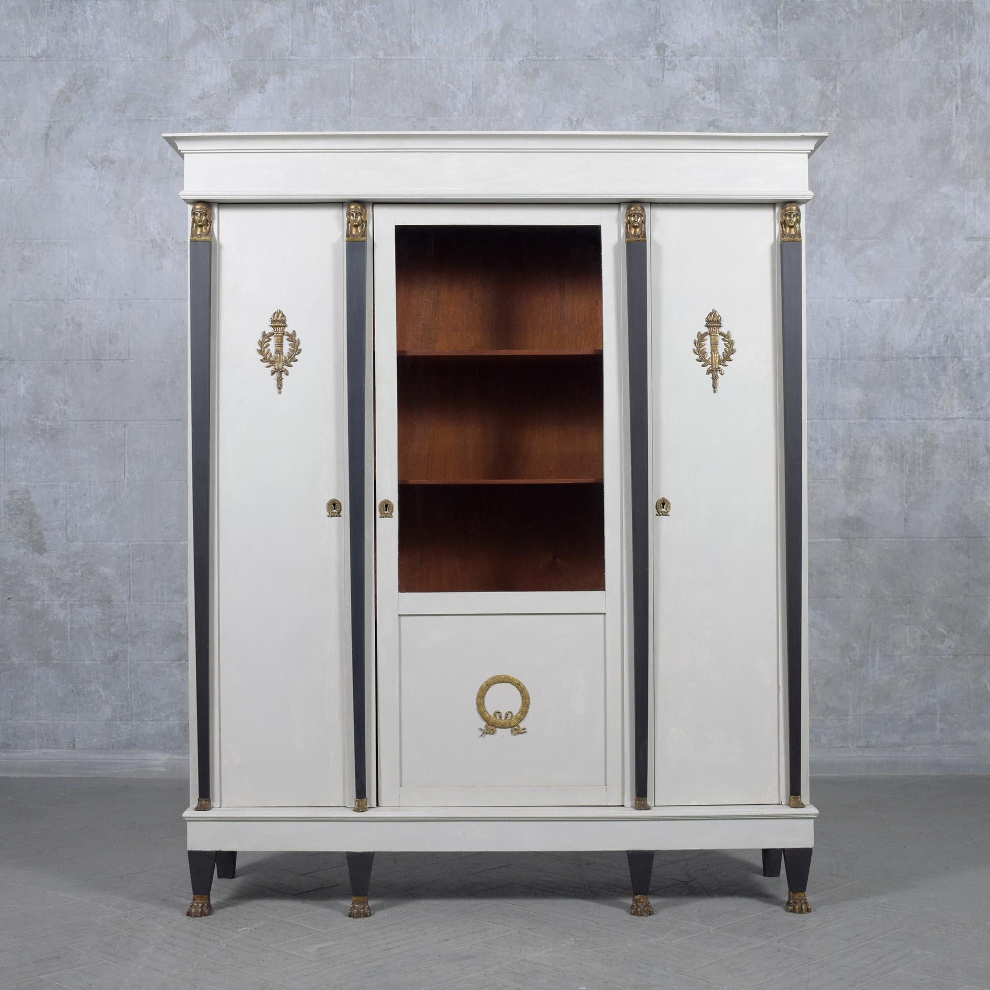Discover the grandeur of our French Empire bookcase, a testament to the artistry and craftsmanship of a bygone era. Expertly handcrafted from mahogany wood and adorned with brass and glass, this antique piece has been meticulously restored and