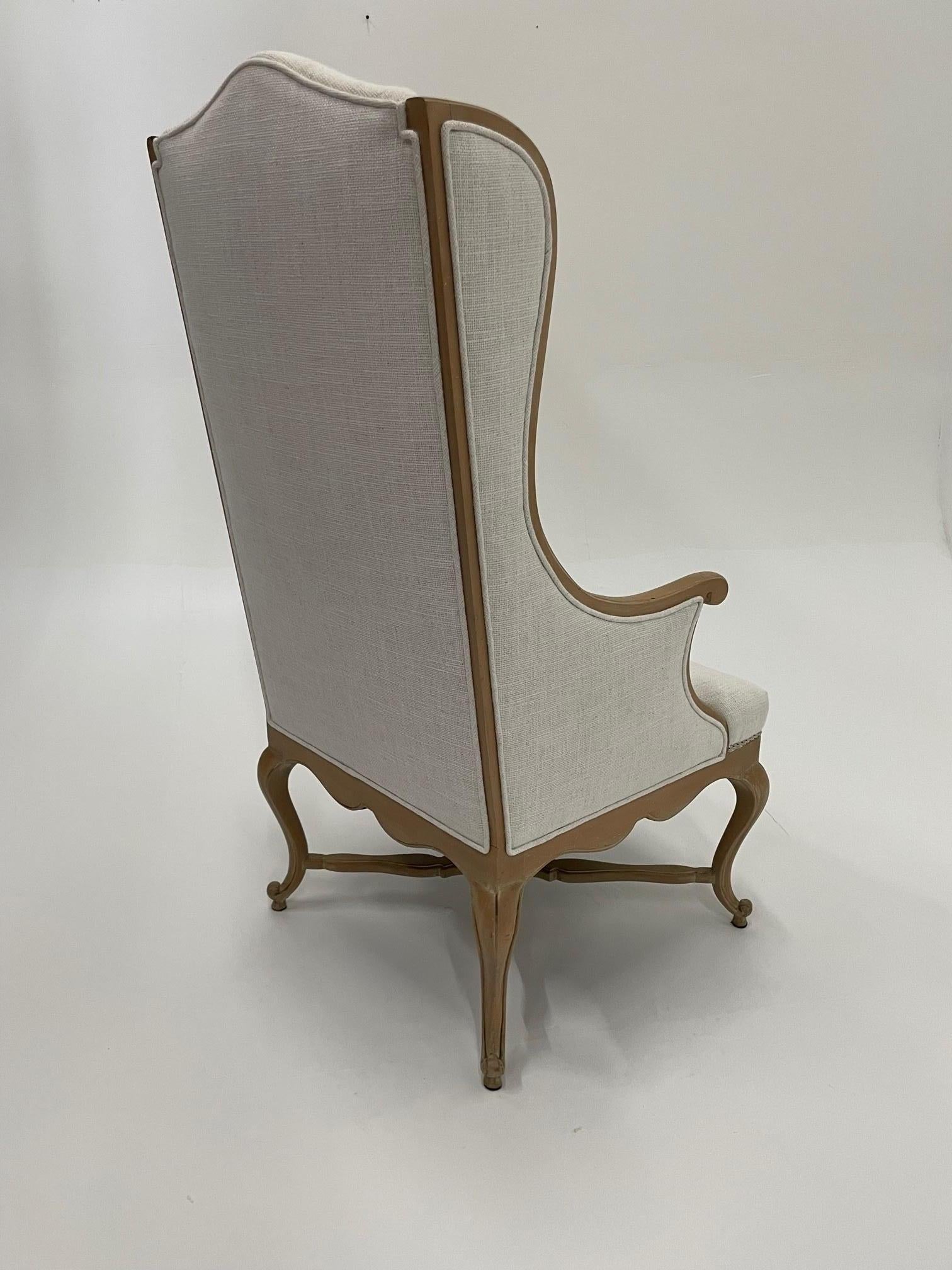 Stunning French Provincial washed oak arm chair having beautiful carved stretcher and neutral white linen upholstery.