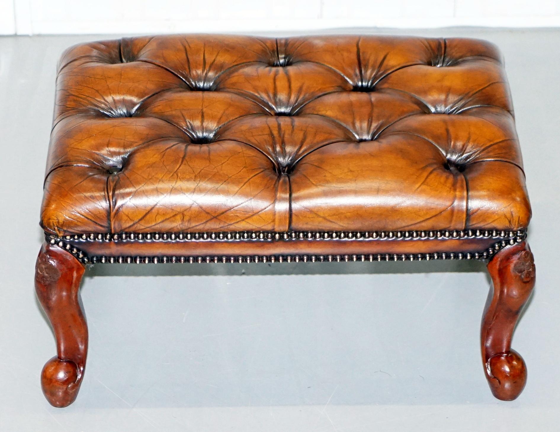 We are delighted to this absolutely stunning original vintage Chesterfield fully restored hand dyed whisky brown leather footstool with ornately carved legs

A very good looking and well made piece, the timber is all solid Mahogany, the legs have