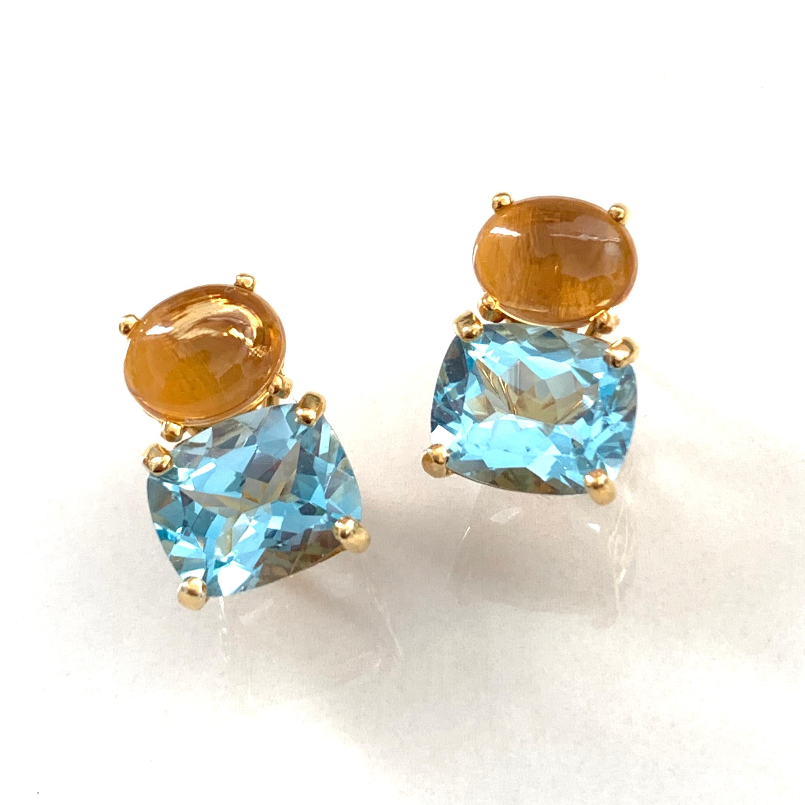 These stunning pair of earrings features a pair of genuine oval cabochon-cut Brazilian citrine with faceted cushion-cut sky blue topaz, handset in 18k yellow gold vermeil over sterling silver. The facet and cabochon combination creates beautiful