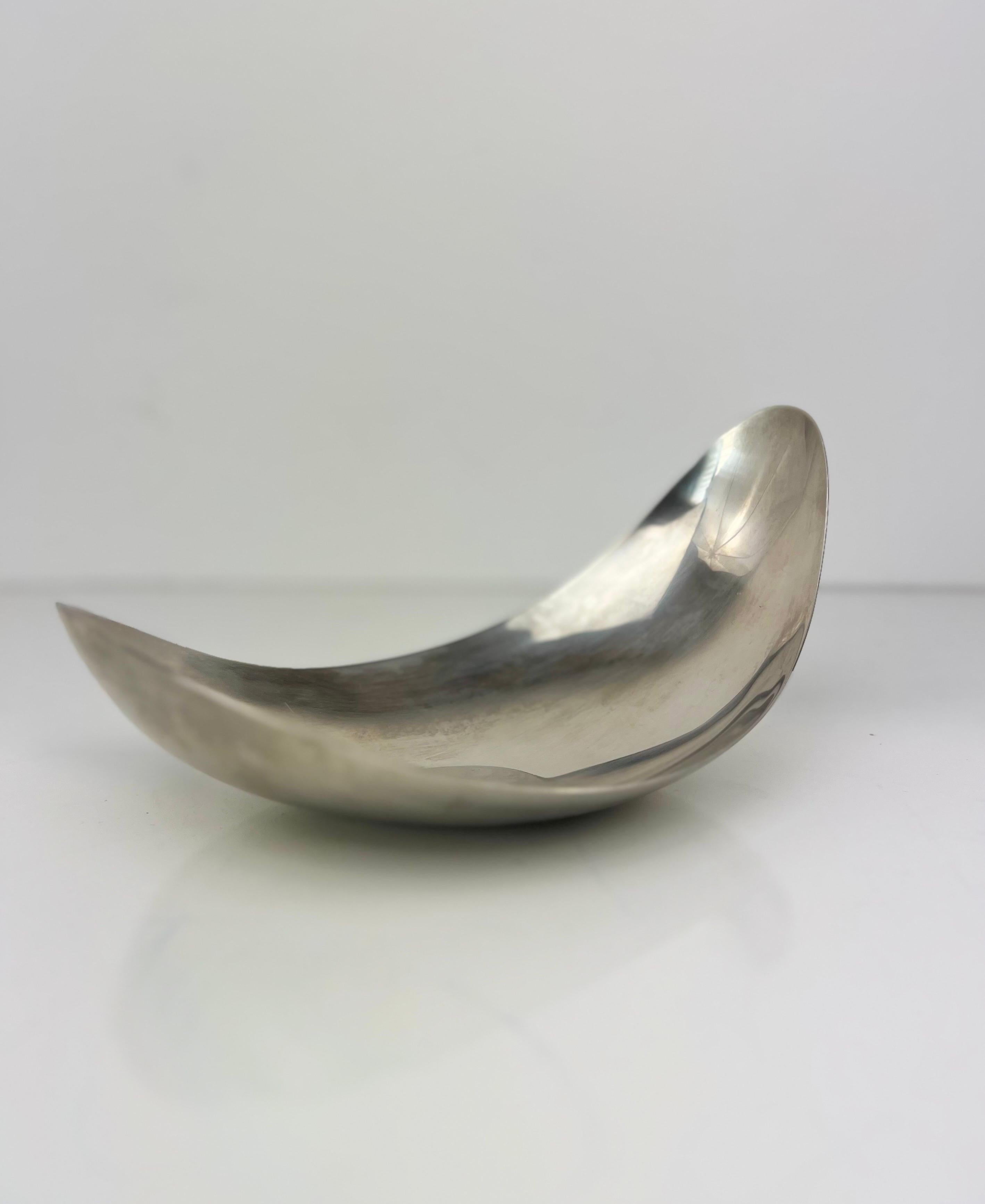 Organic modern mid century bowl by artist Georg Jensen.  The brushed stainless steel curved design reflects light in the most stunning way.  Made in Denmark.  The shape is inspired by the magnolia flower. Stamped George Jensen on the bottom. 