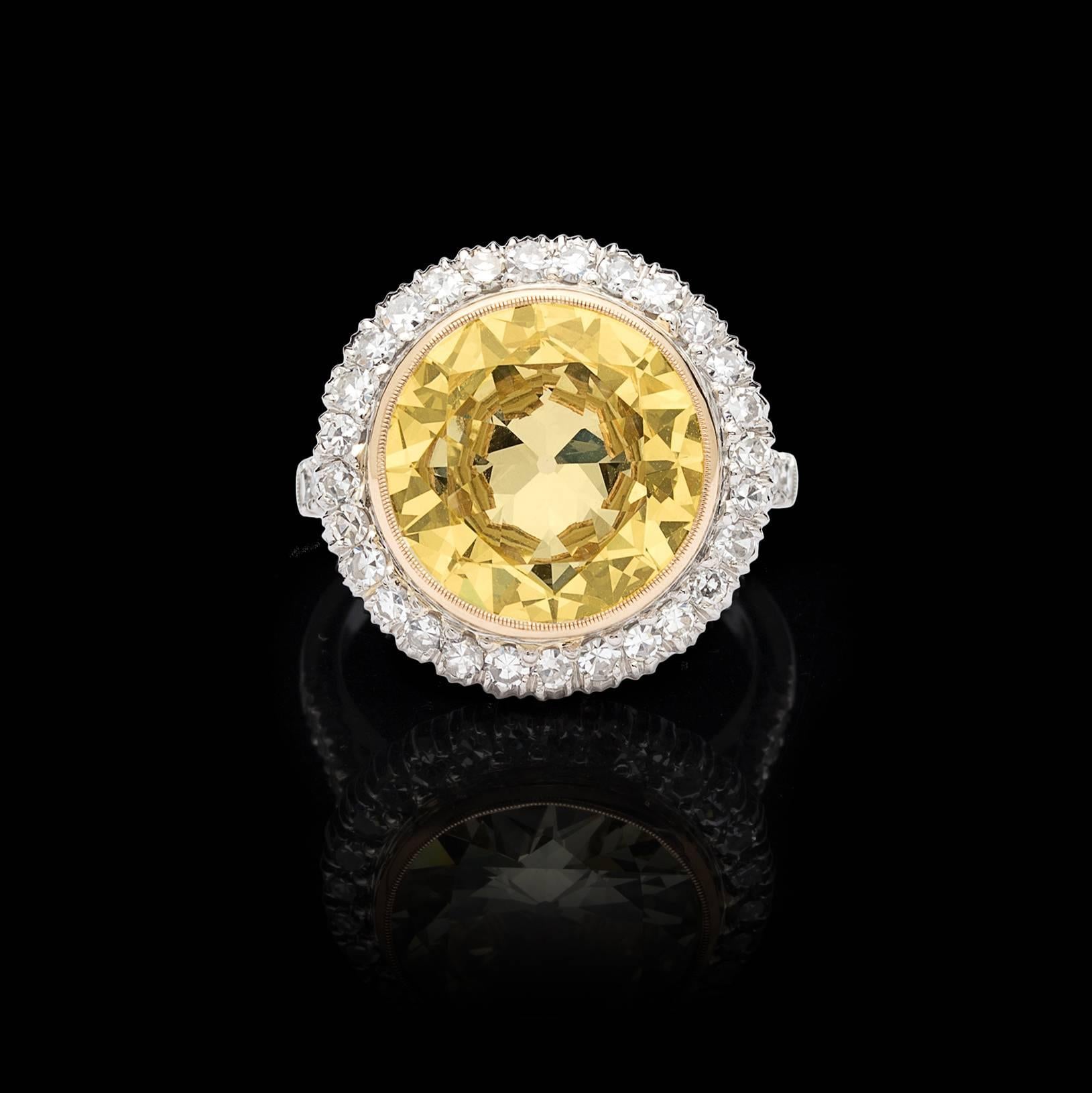 This is a ring that will stop traffic. Showcasing a 6.18-cts. circular-cut Fancy Light Yellow diamond, with impressive VVS2 clarity, bezel-set in yellow gold on a platinum mount and framed by 38 sparkling single-cut diamonds, weighing in total an