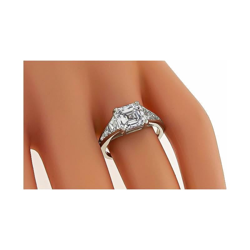 This gorgeous platinum engagement ring is centered with a sparkling GIA certified asscher cut diamond that weighs 2.50ct. graded I color with VVS2 clarity. Accentuating the center stone are dazzling trapezoid cut diamonds that weigh approximately