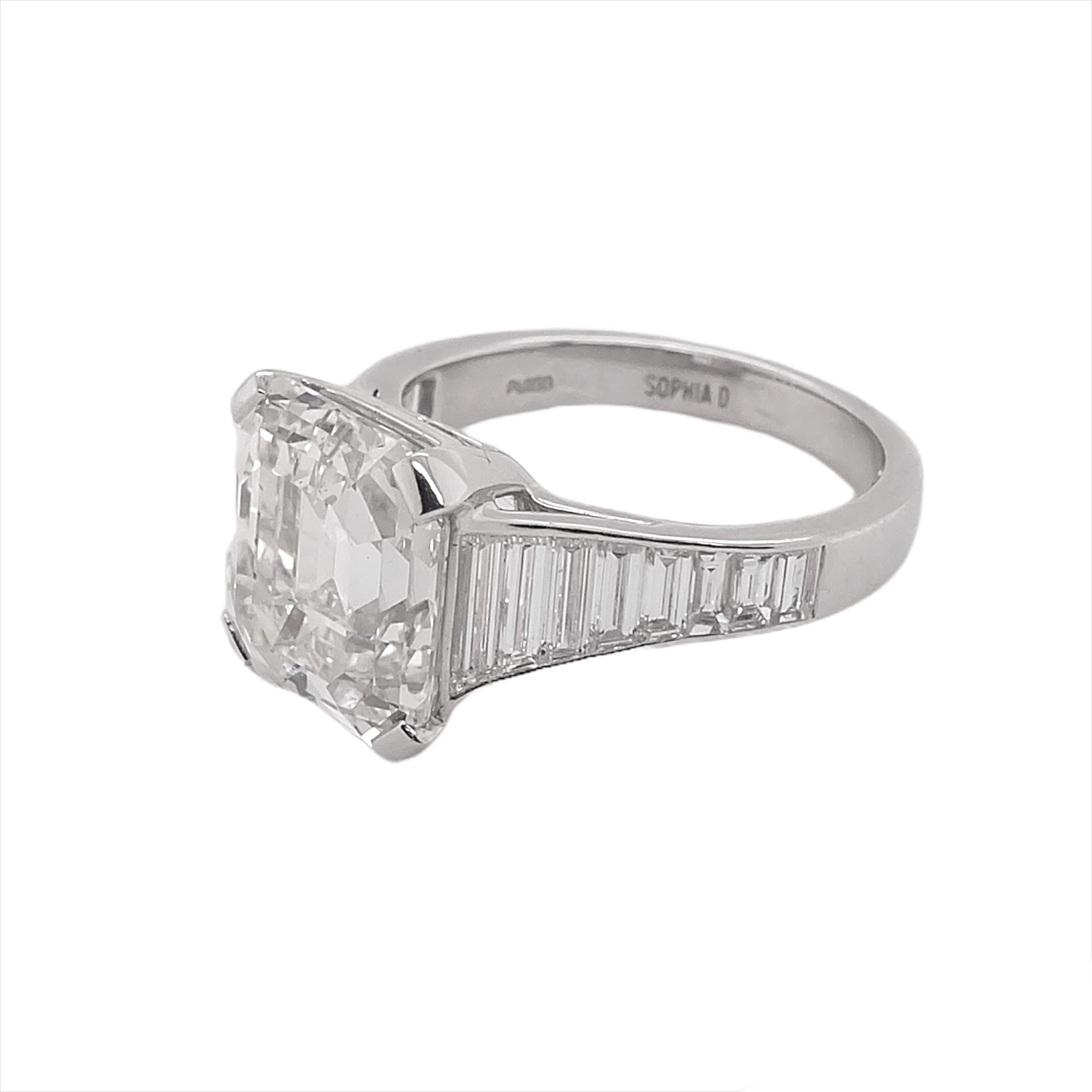 GIA certified diamond ring features a diamond center stone that weighs 6.04 carat with a color and clarity of L- VVS2 and accentuated with baguette cut diamonds that weigh 0.85 carat and small diamonds that weigh 0.27 carat.