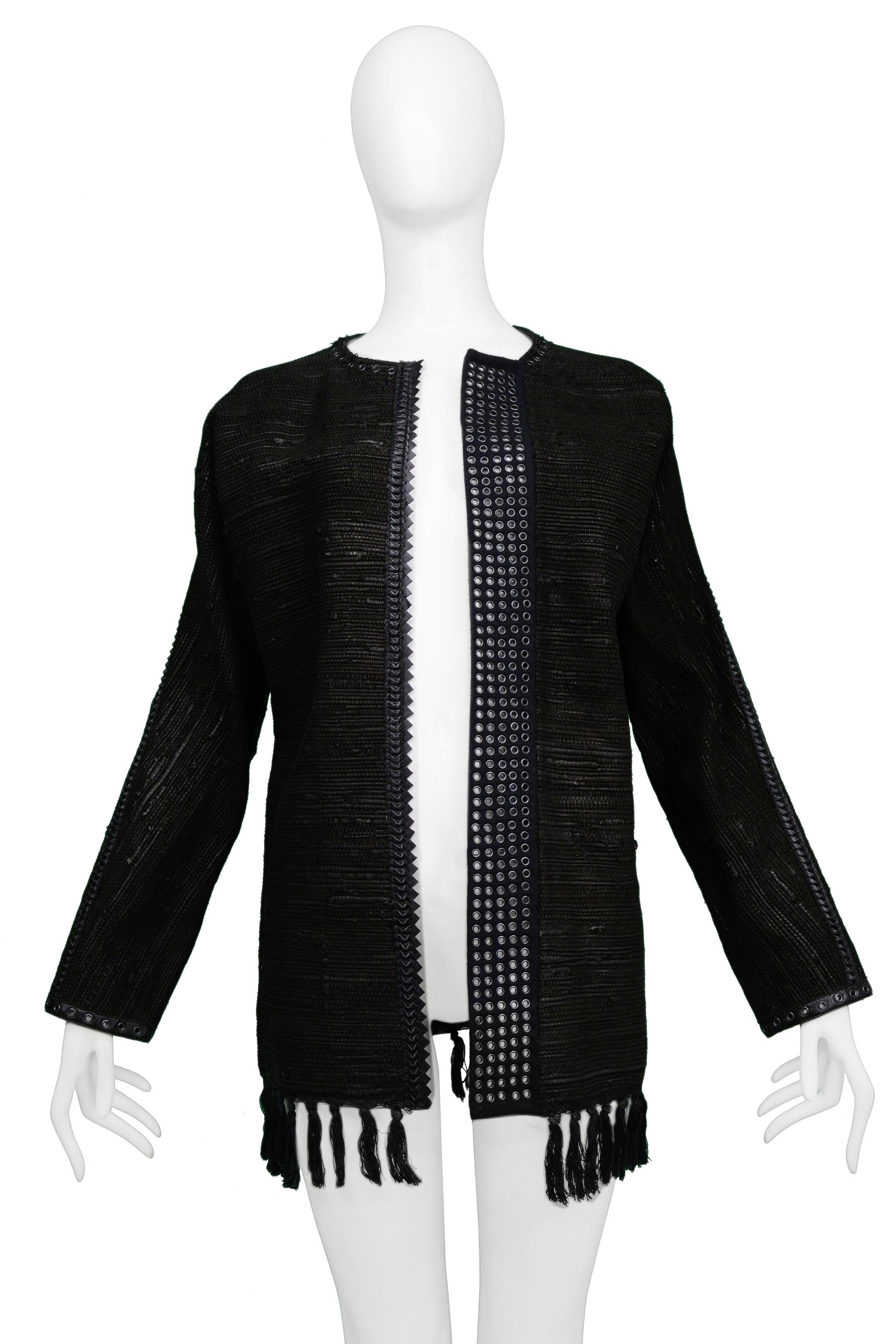 Resurrection Vintage is excited to offer a vintage Gianfranco Ferre black leather and textured wool collarless jacket featuring black leather trim, black leather lacing at the seams, rows of silver-tone grommets, center front zipper, and fringe