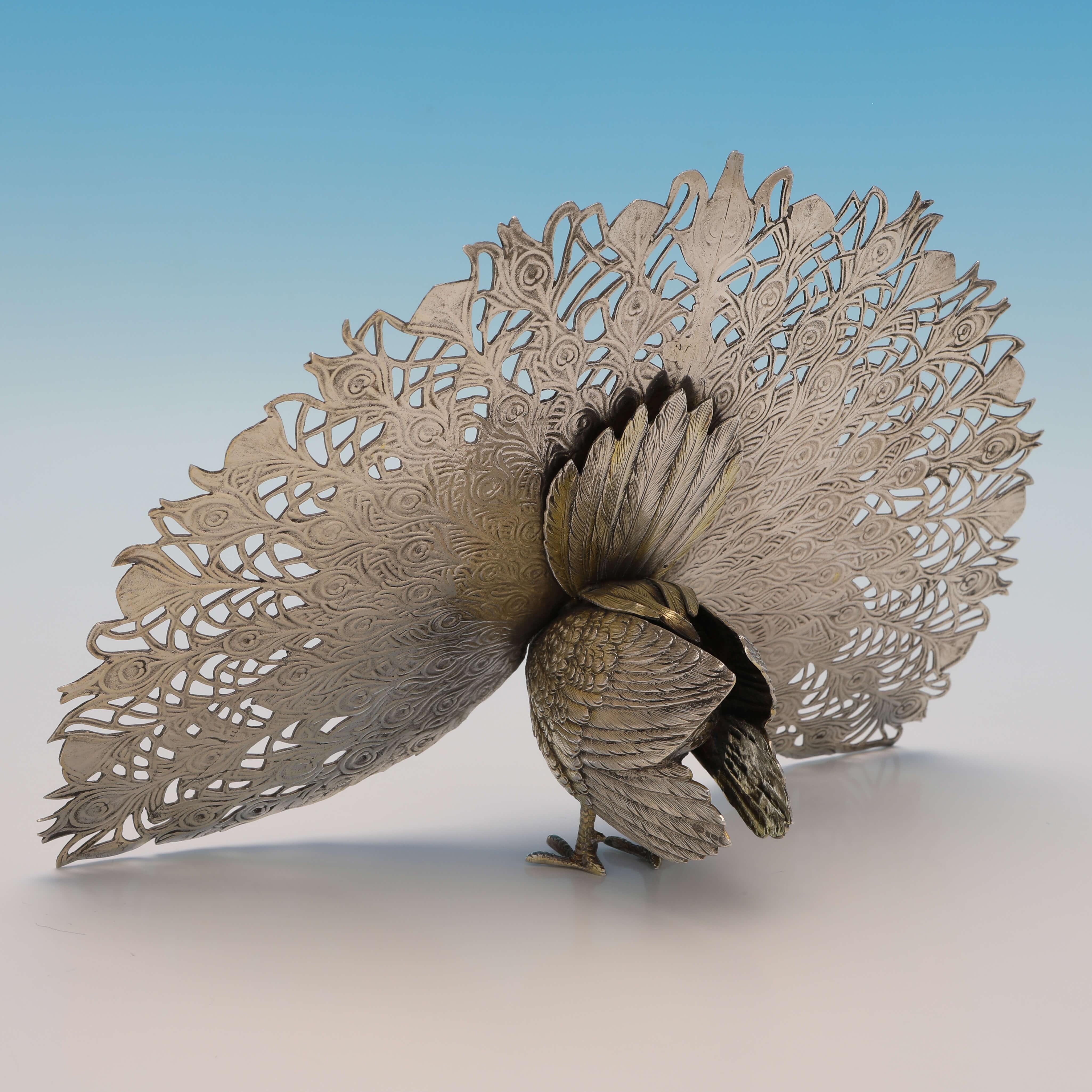 Carrying import marks for London in 1970 by I. Freeman & Sons, this charming, Sterling Silver Model of a Peacock, features gilt detailing to the body and tail feathers. 

The peacock measures 6.25