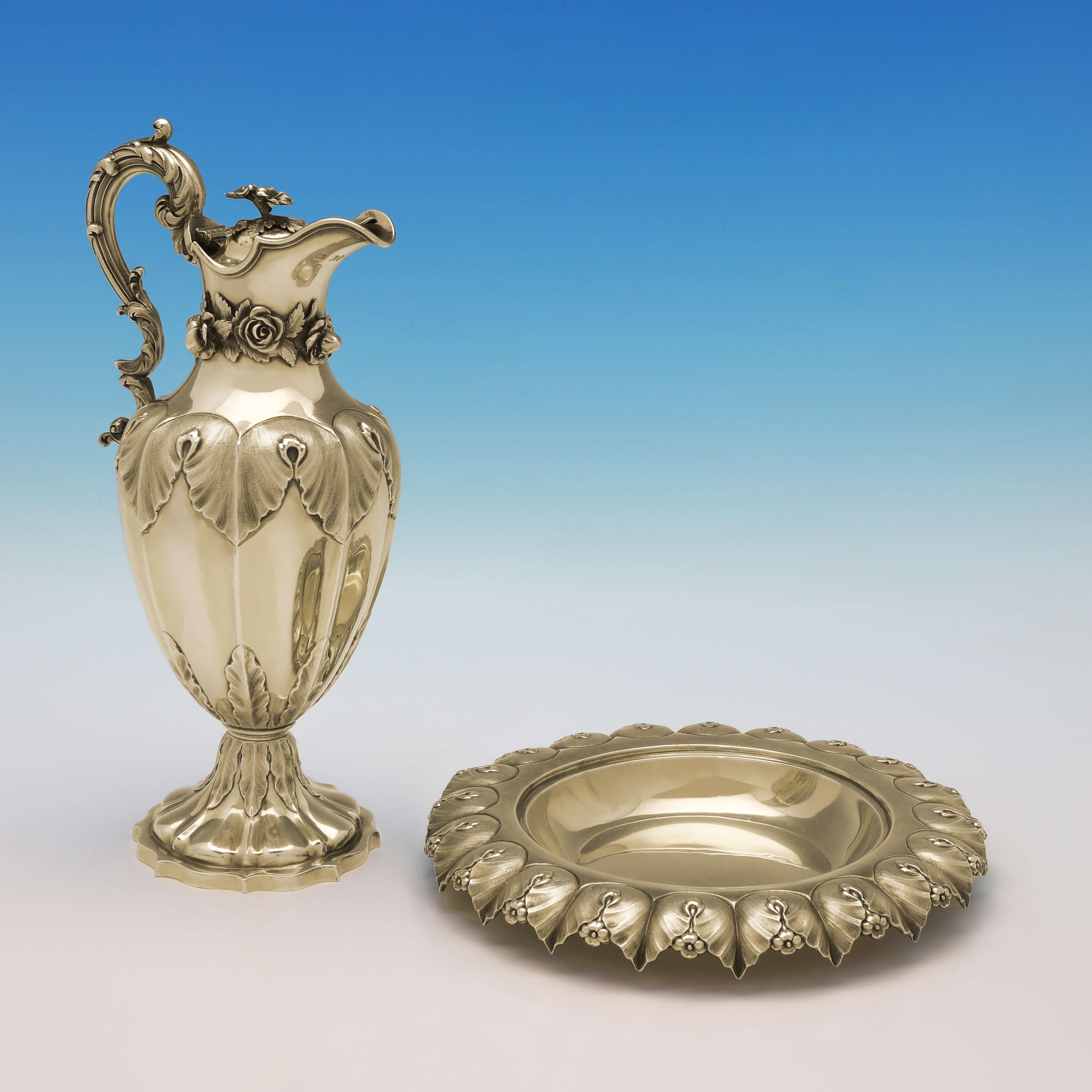 Hallmarked in London in 1830 & 1836 by Barnards, this stunning, Antique Sterling Silver Wine Ewer on Stand, features chased acanthus and rose detailing, cast and applied roses around the spout of the jug, an ornate handle, and the original gilding.
