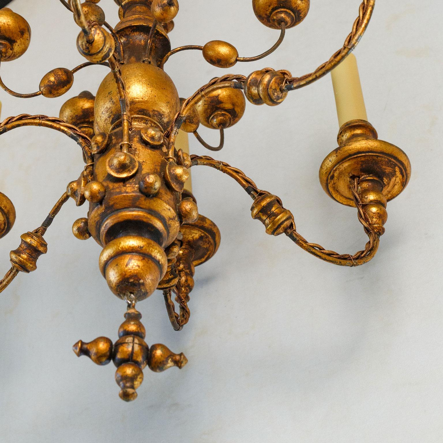 Mid-20th Century Stunning Gilt  Italian Chandelier of Metal and Wood with  playful design.  For Sale