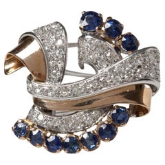 Superbe broche en or avec saphirs et diamants.