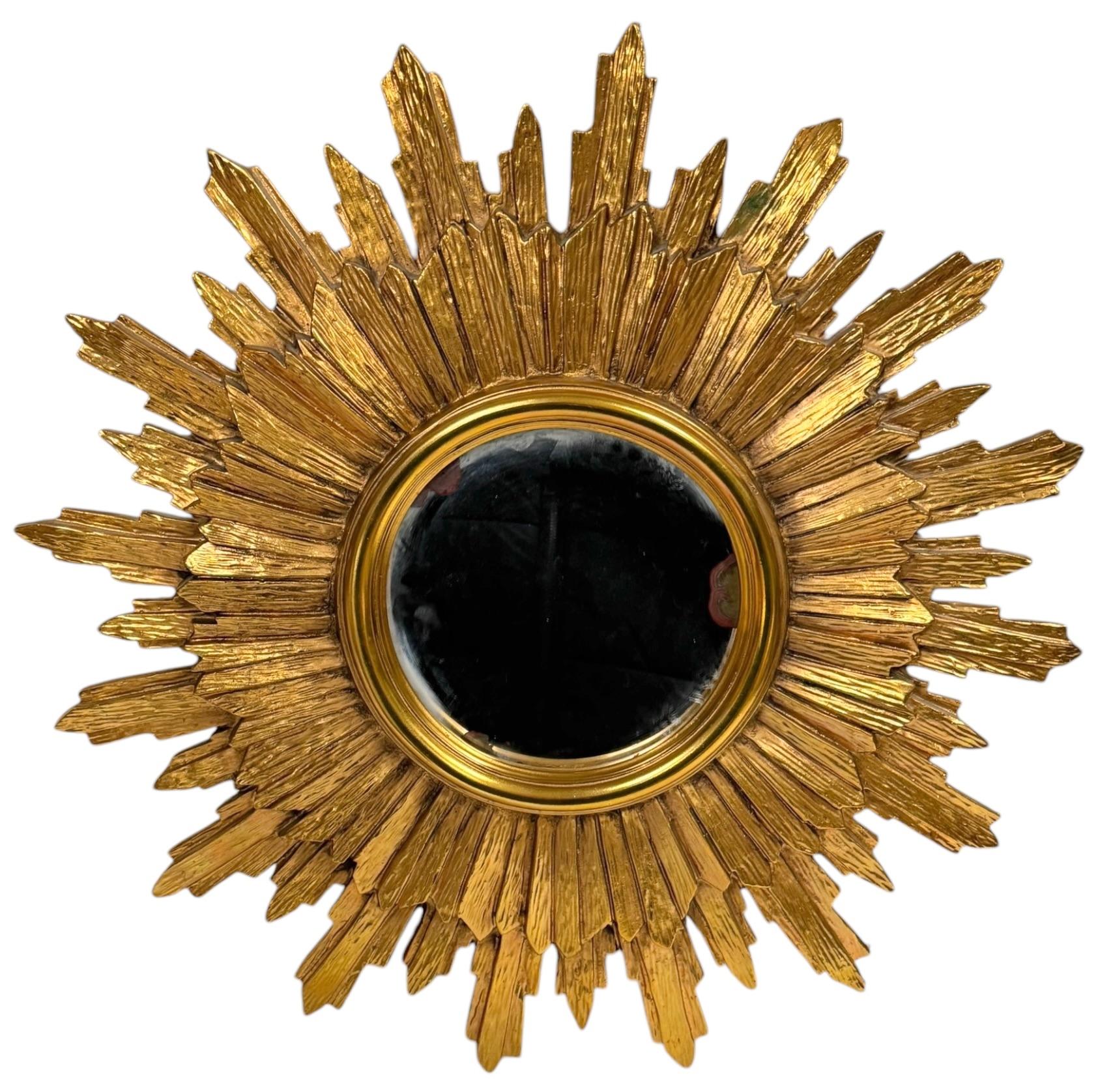 A gorgeous starburst sunburst flat mirror. Made of gilded resin. No chips, no cracks, no repairs. It measures approximate: 19.75