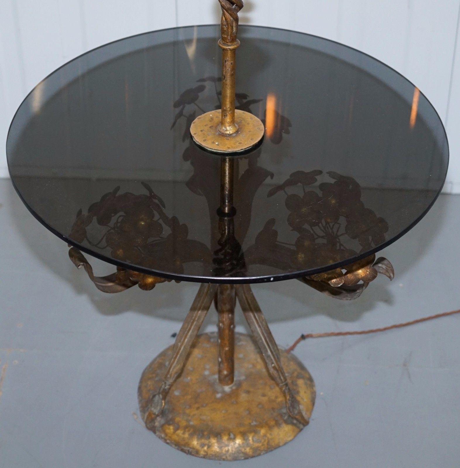 We are delighted to offer for sale this large gold leaf painted floral side table with smoked glass and built in lamp

Purchased from Harrods 11 years ago this stunning contemporary lamp is a real signature piece

The condition is excellent