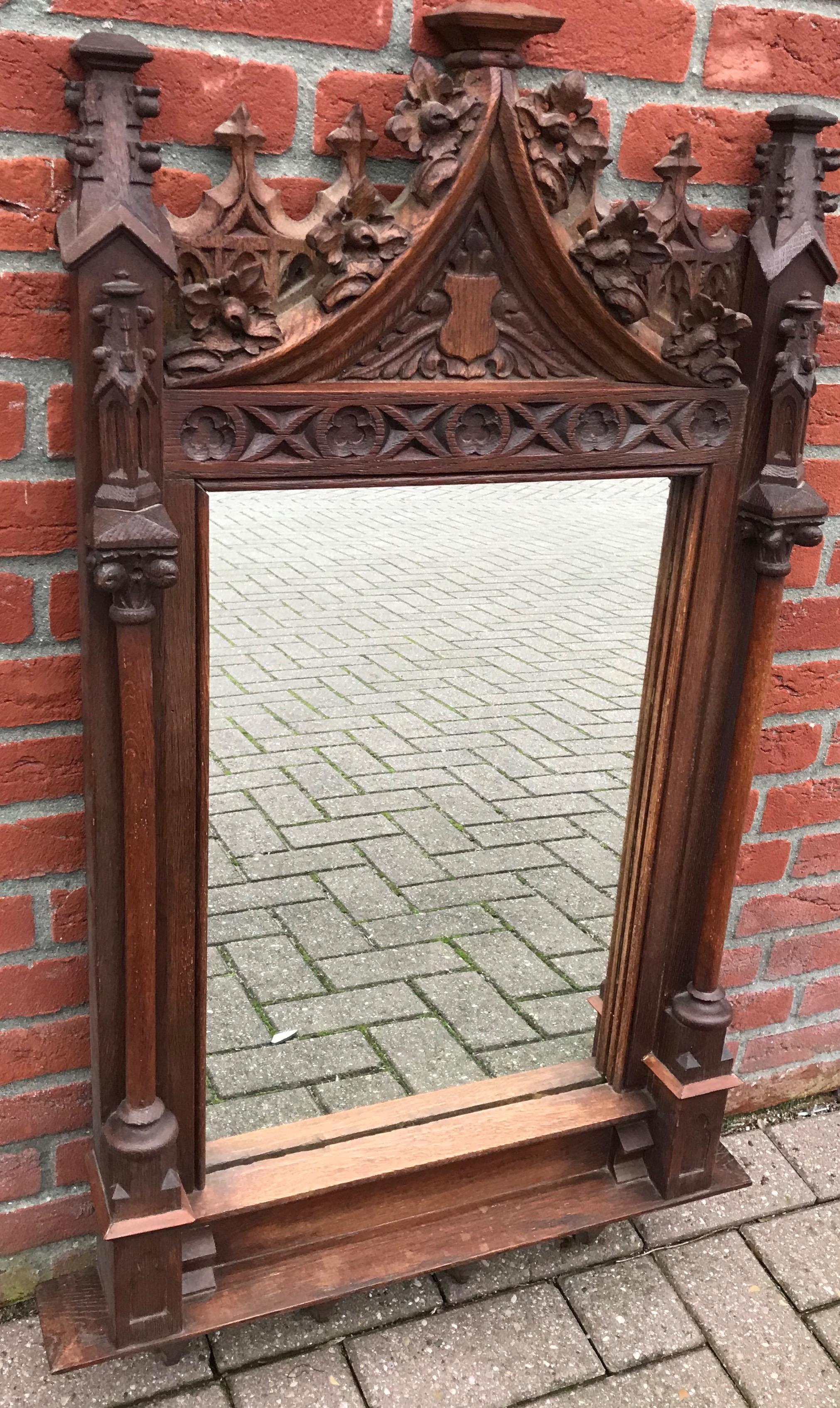 Beautiful Gothic wall mirror with handcrafted frame.

This wonderful and all handcrafted wall mirror from the late 1800s will look great, no matter where you decide to hang her. In a large entrance, over a mantel piece, on the wall beside your