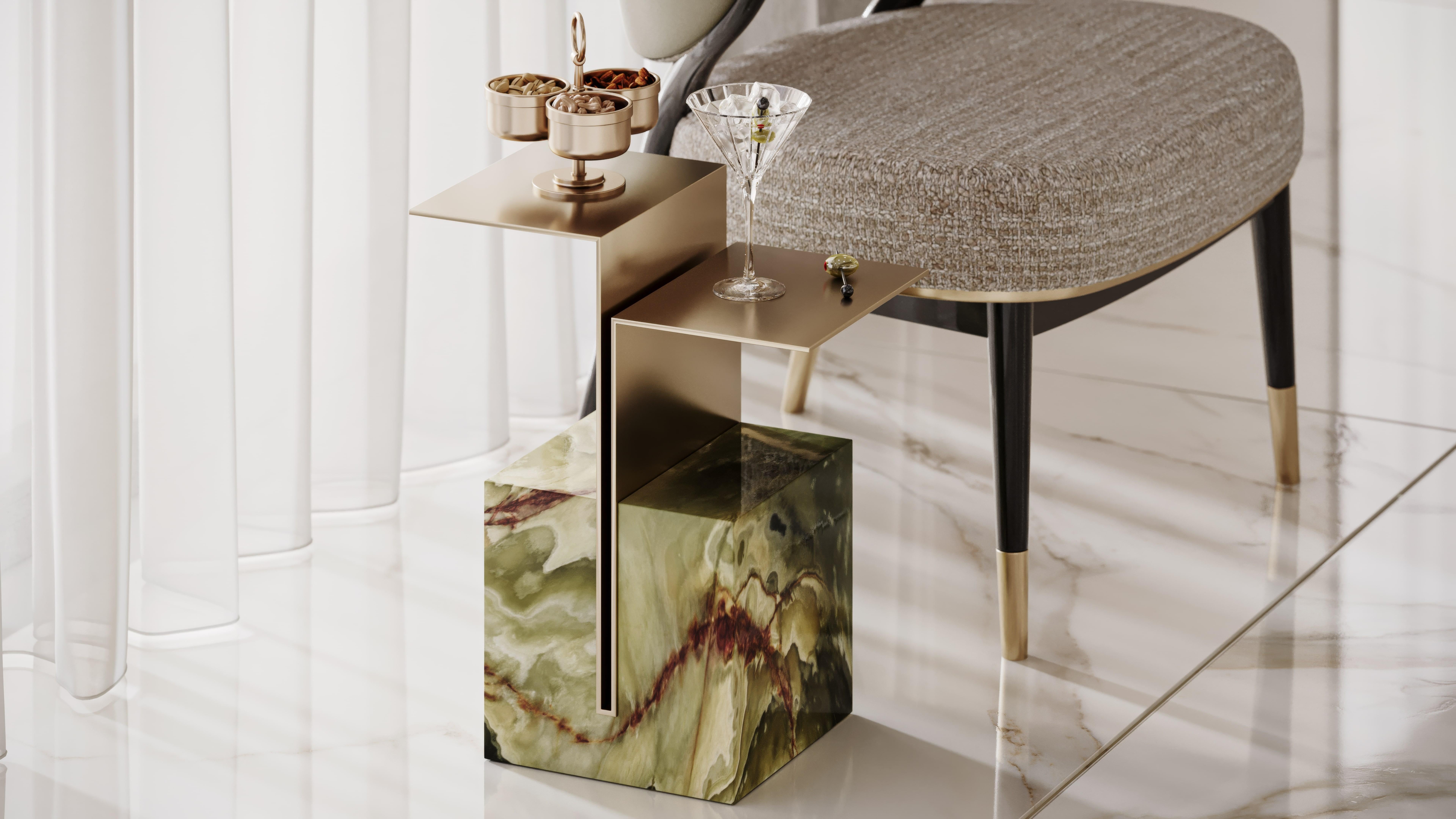 Brok is a striking side table featuring a minimalist brass top and a stunning green onyx base. This piece combines natu ral elegance with a modern aesthetic, adding a touch of luxury to any space. The brushed brass top contrasts beautifully with the