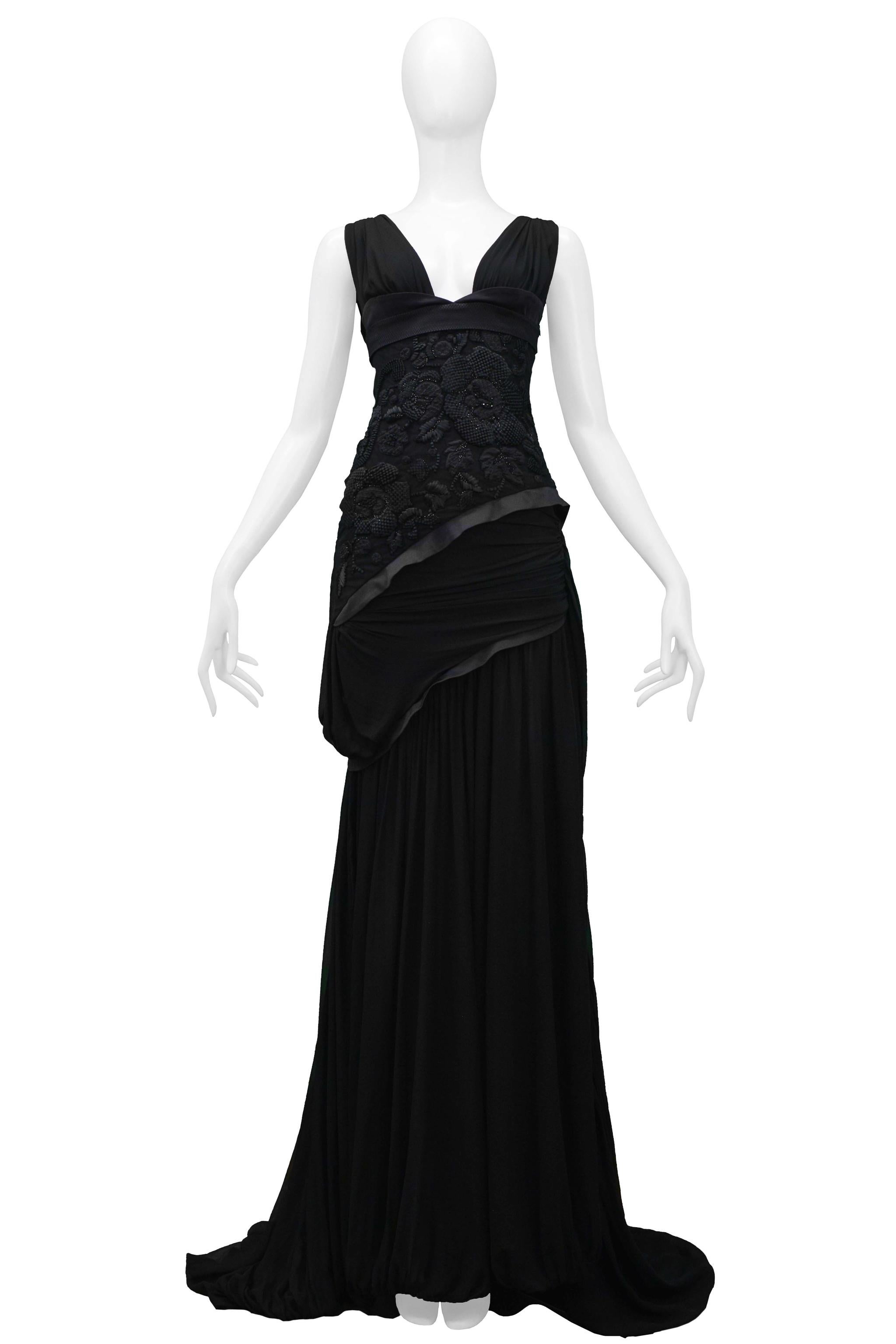 Resurrection Vintage is excited to offer a stunning vintage black Gucci silk evening gown featuring a heavily embroidered bodice and back yoke, deep V neckline, gathered insets, contrasting trim, cutout back, and gown length with train. 

Gucci
Size