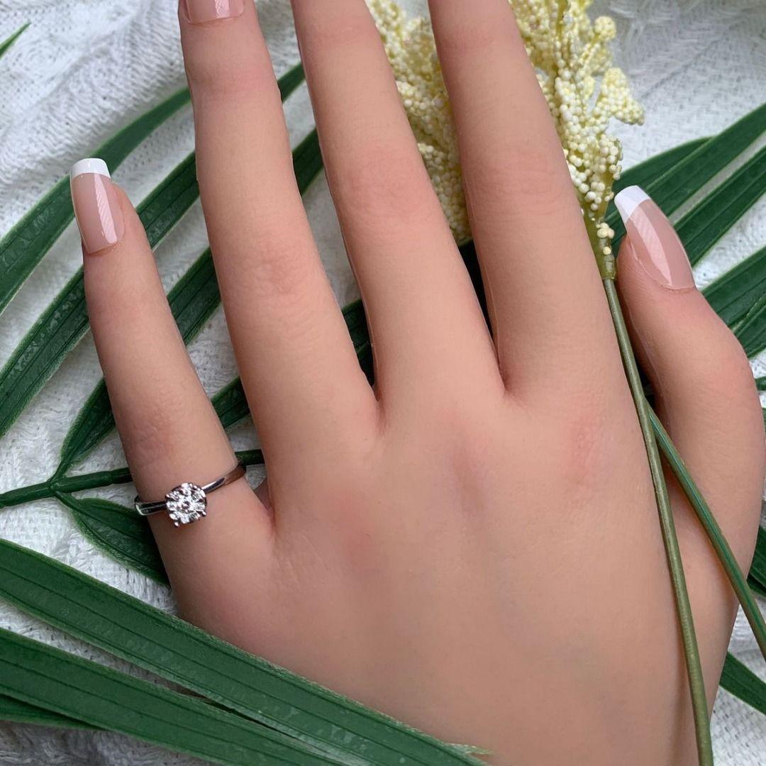 The Stunning Halo Ring in 9K White Gold is a versatile and striking accessory that can complement a wide range of styles, from traditional to modern. It serves as a symbol of beauty and grace, making it a treasured piece that can be worn with pride
