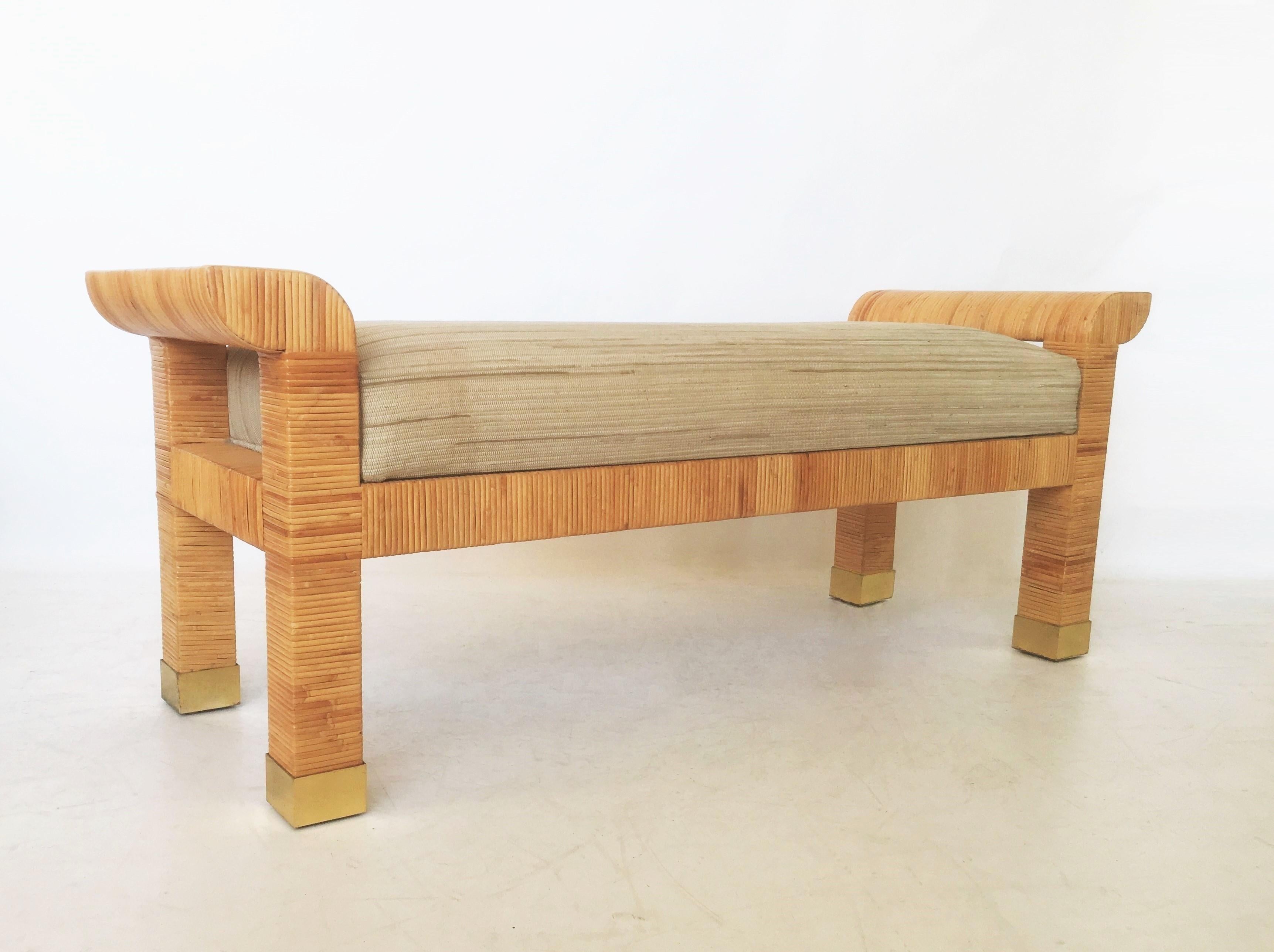 Exceptional style and quality. This stunning bench designed by Billy Baldwin for Bielecky Brothers, circa 1985. Expertly crafted hardwood form painstakingly hand-wrapped in cane, upholstered seat, legs ending in with brass sabots. All cane wrapping