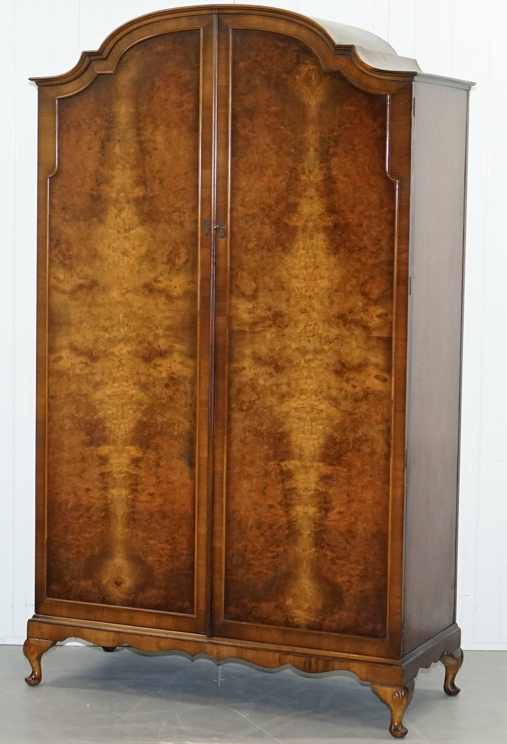 We are delighted to offer for sale this lovely handmade in England flamed walnut double wardrobe with cabriolet legs 

A very good looking and well-made piece in period condition, this wardrobe offers storage for hanging full-length items on the