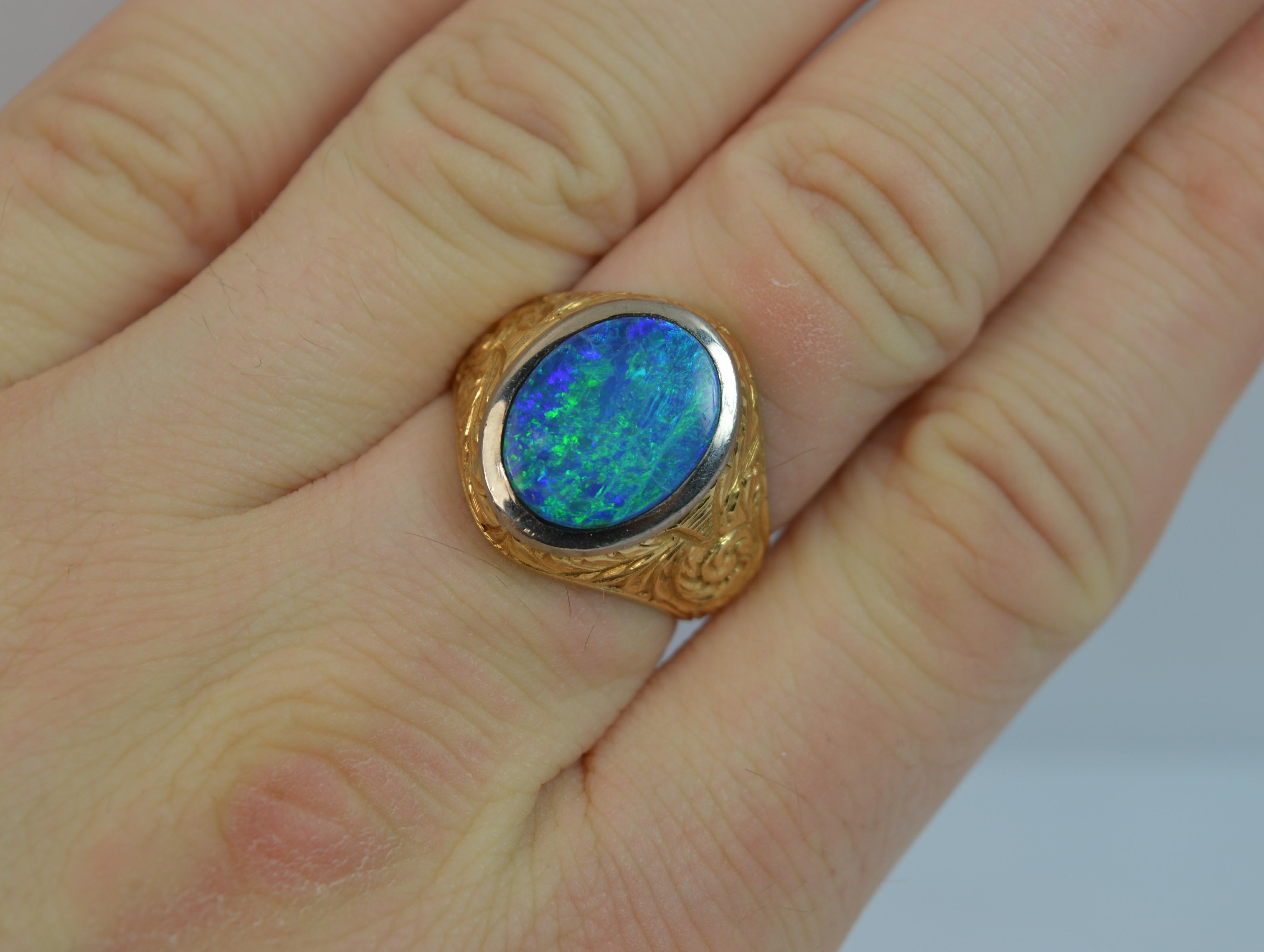 
A superb 18ct Gold and Opal doublet ring.

Signet ring design with the opal to centre measuring 10mm x 13.5mm approx.

Superb hand engraved chased finish to the shoulders and full shank.


CONDITION ; Excellent. Clean and solid shank. Crisp