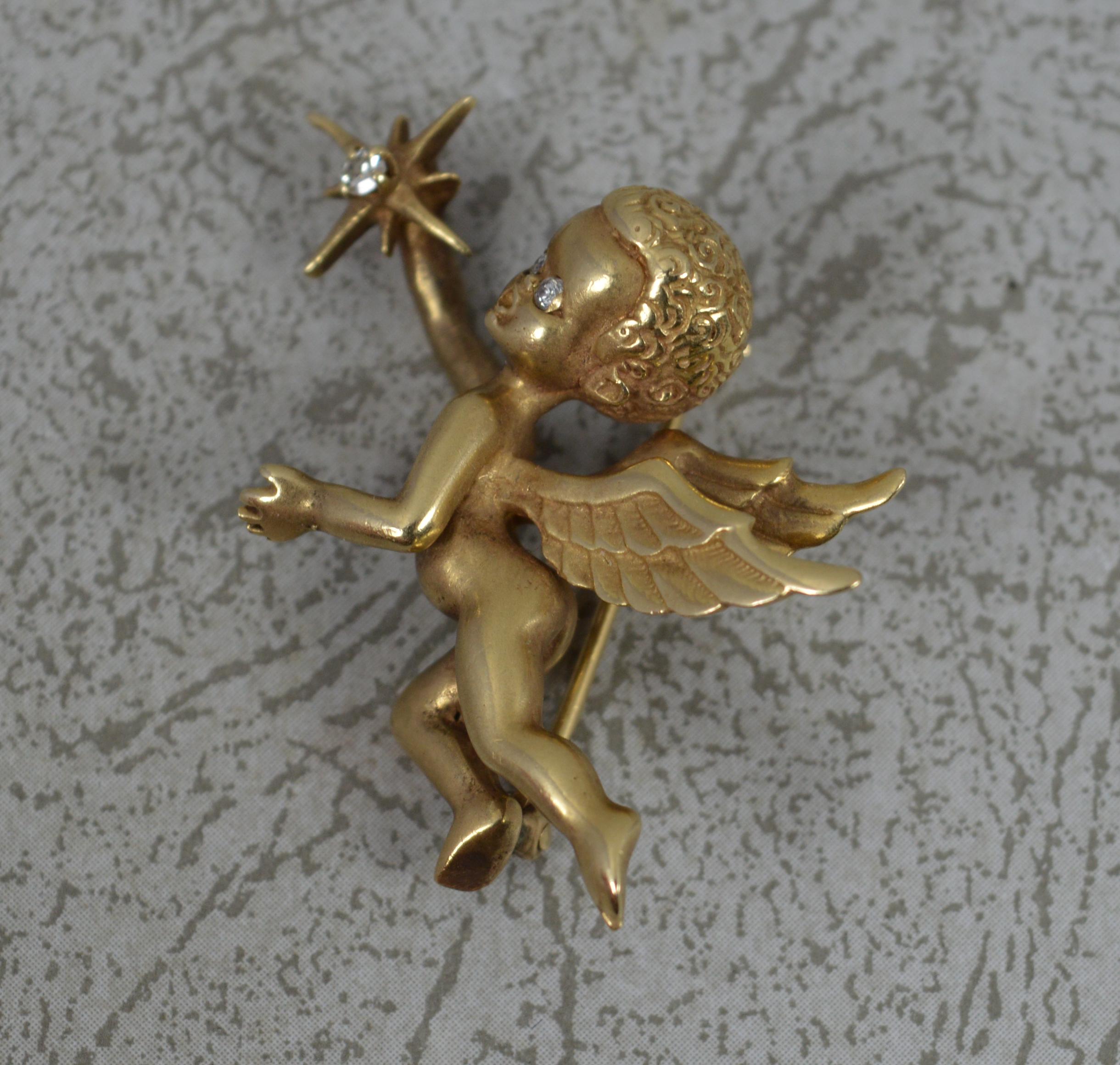 A captivating vintage brooch of cherub holding a star.
Solid 14 carat yellow gold example, very weighty, solid example. Set with three diamonds.
Well made example. A large shape and size. A detailed example.

CONDITION ; Excellet. Very crisp design.